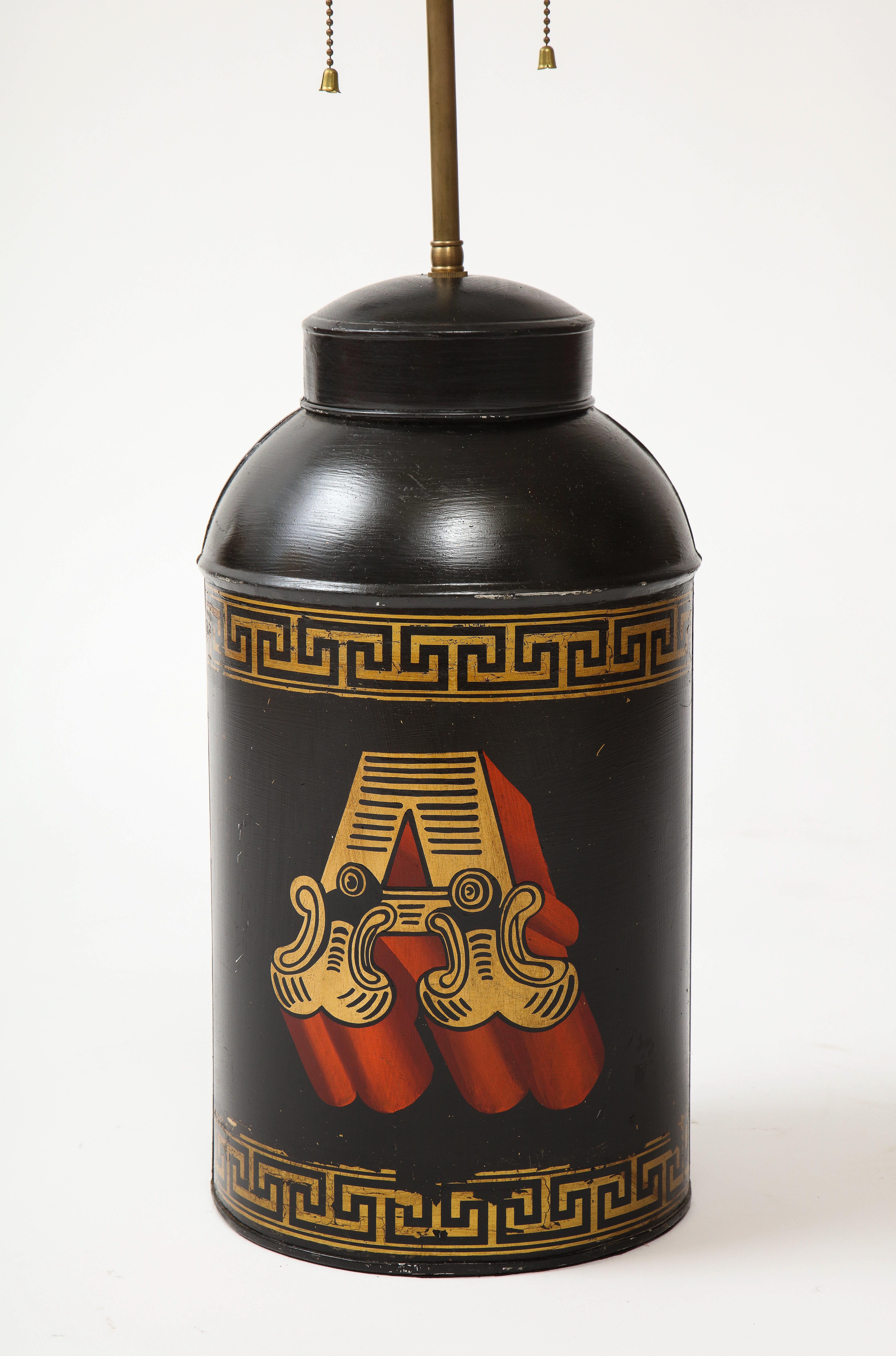 Of cylindrical form; decorated with a large gilt and red letter 