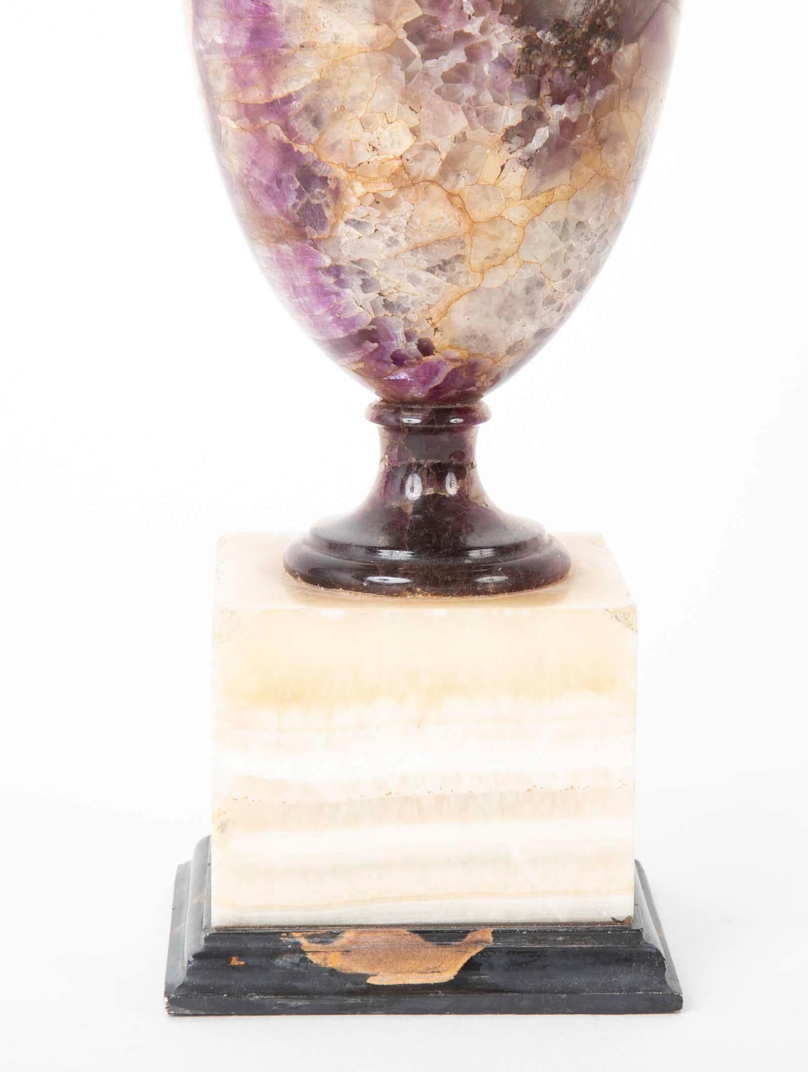 An English blue John covered urn form Orniment raised on white Florite plinth with a molded Portoro base, circa late 18th-early 19th century.