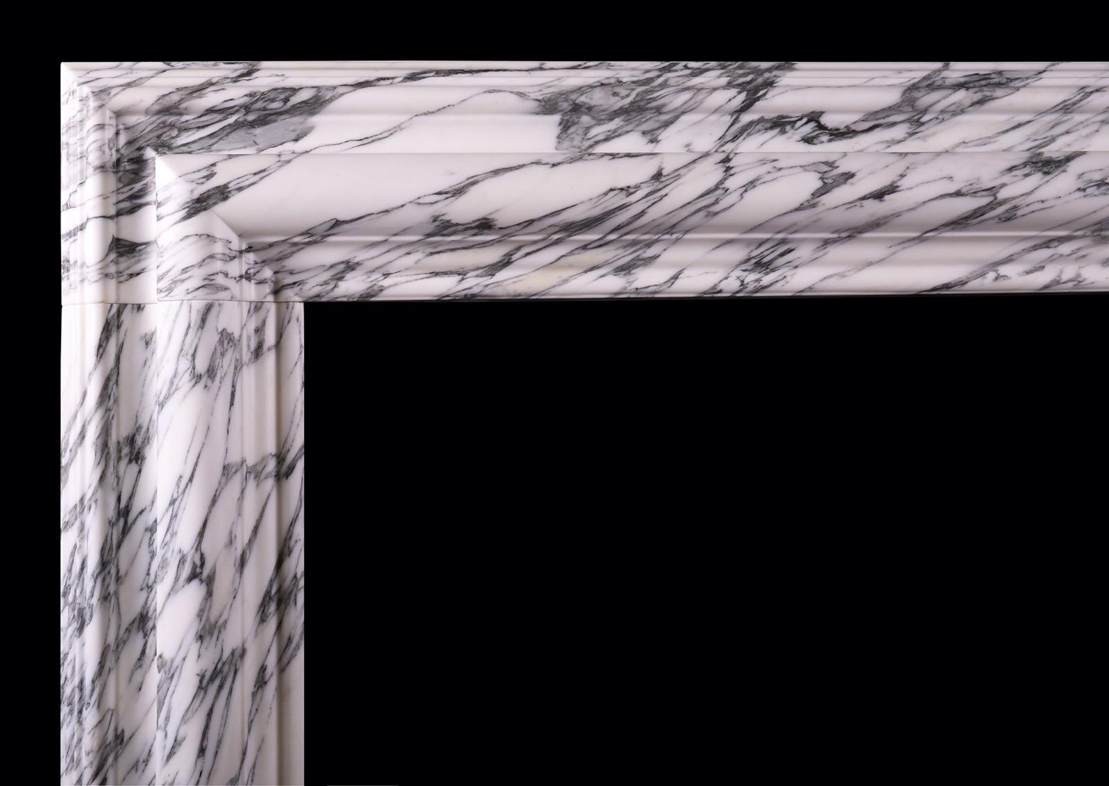 An English bolection in Italian Arabescato marble. The moulded frieze and jambs with plain footblocks below. A nicely shaped profile. Modern, could be made to bespoke sizes if required.

Shelf Width:	1500 mm      	59