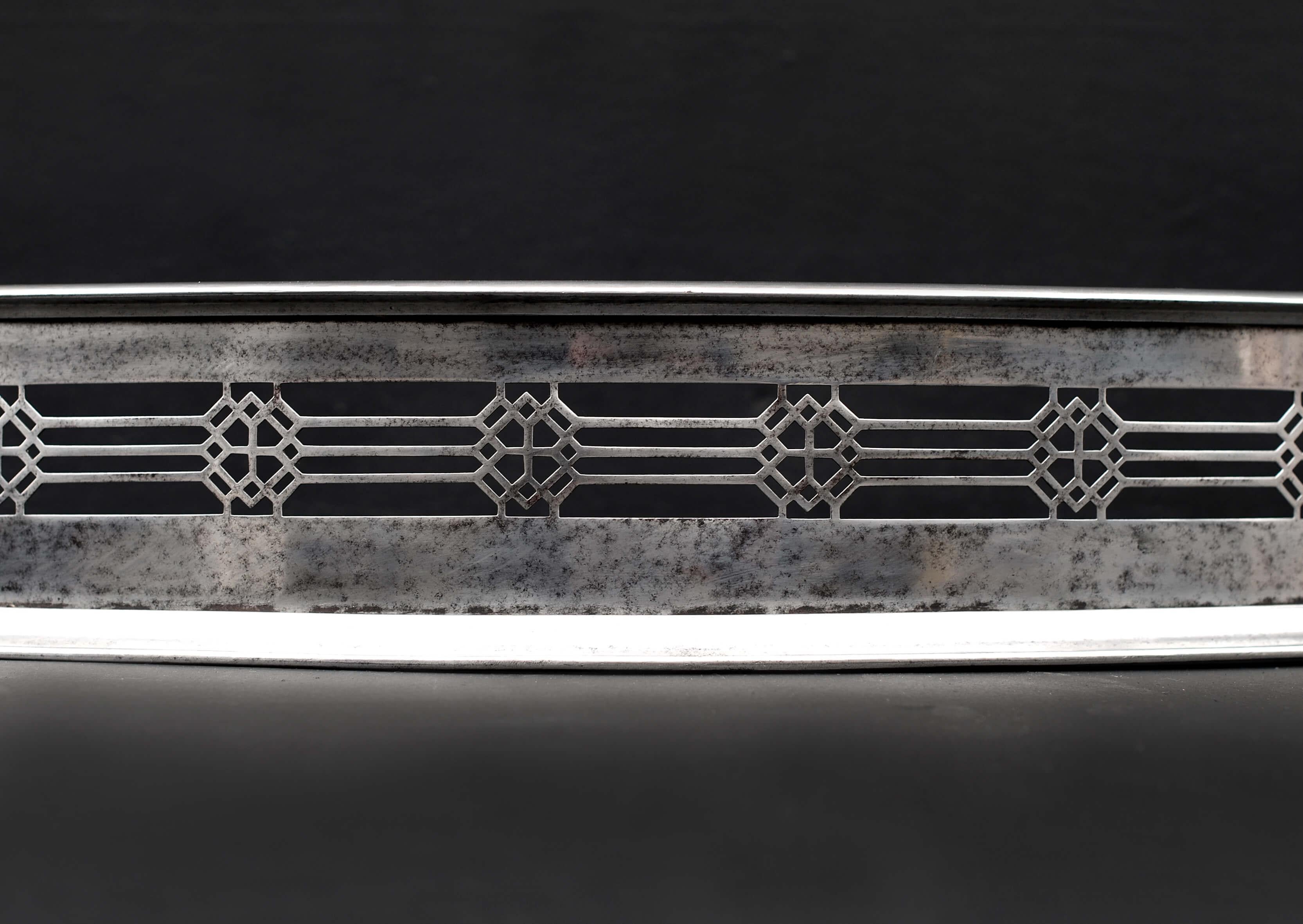 A 19th century steel compassed steel fender, with pierced isometric fretwork.

External Width:	1245 mm      	49