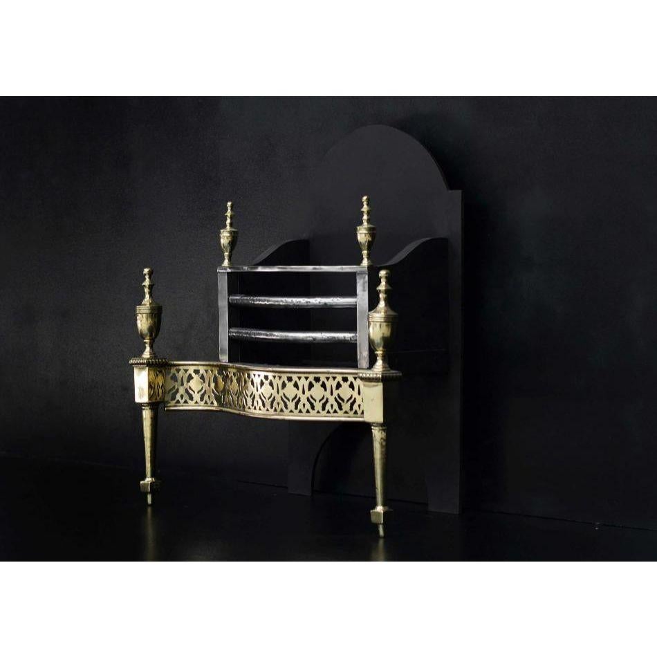 A good quality English brass and steel firegrate.  The tapering legs surmounted by brass fret with beading and paterae. The polished steel uprights with decorative brass adornments, surmounted by brass finials. Decorative bars to burning area, with
