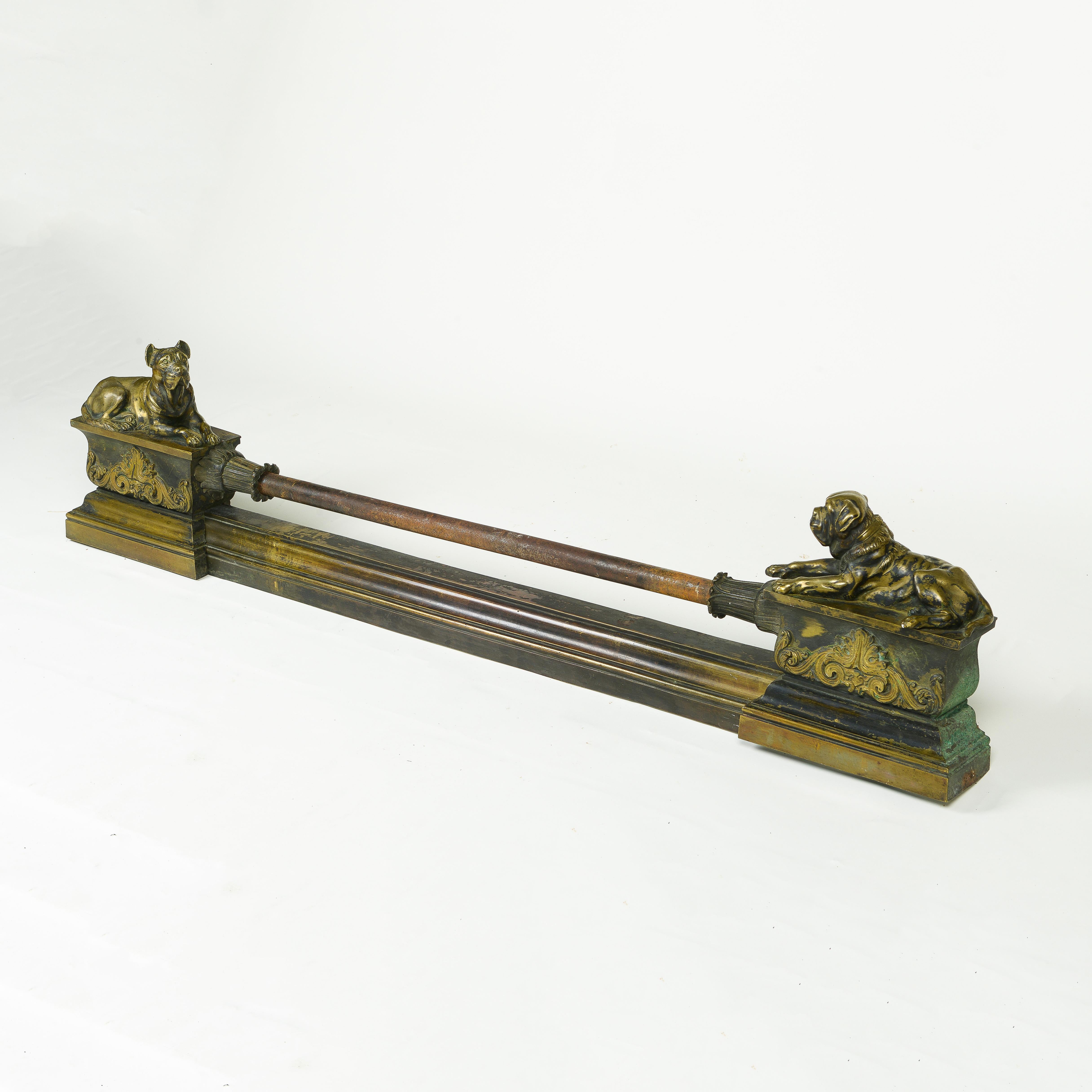 The lotus leaf-wrapped front rail set between two pedestals, one surmounted by a recumbent boxer and the other with a bull dog.