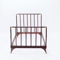An English brass mounted mahogany campaign bed, circa 1900.