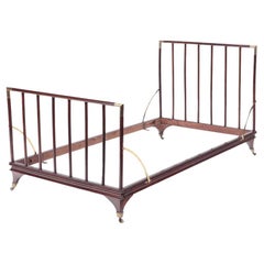 Antique An English brass mounted mahogany campaign bed, circa 1900.