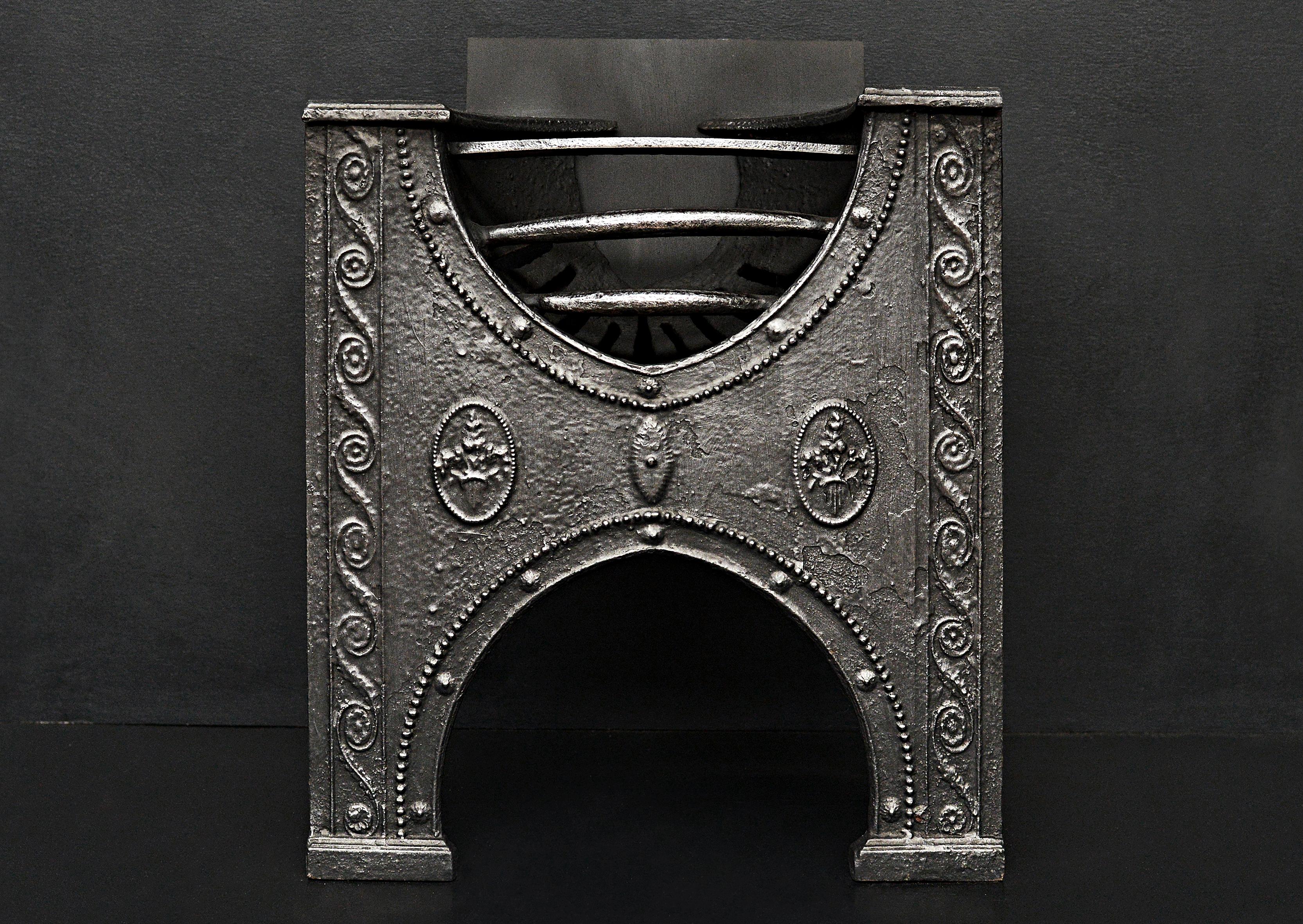 An English cast iron hob grate of small scale. Scrollwork, beading and patera to cast front. 19th century.

Width At Front:	490 mm      	19 ¼