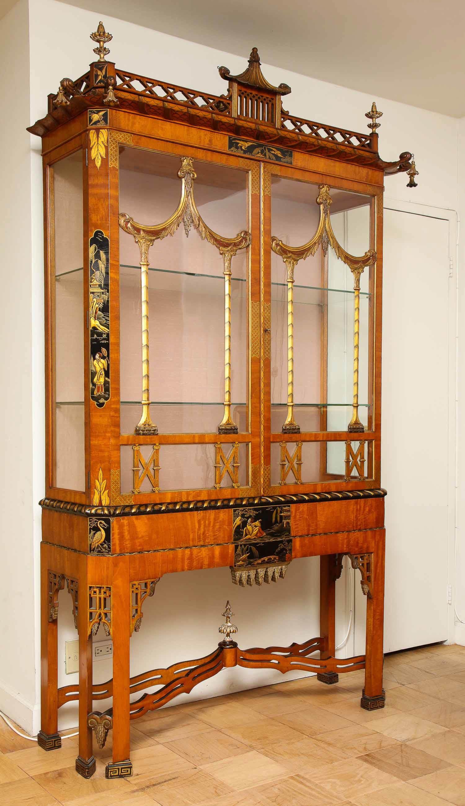A quite unusual 19th century English, 18th century style, chinoiserie pagoda shaped giltwood and black lacquered vitrine/display cabinet/showcase. Beautifully hand carved, this gorgeous vitrine exemplifies the true essence of the 18th century