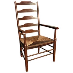 Ein englischer Cotswold School Oak Ladder Back Rush Seat Sessel