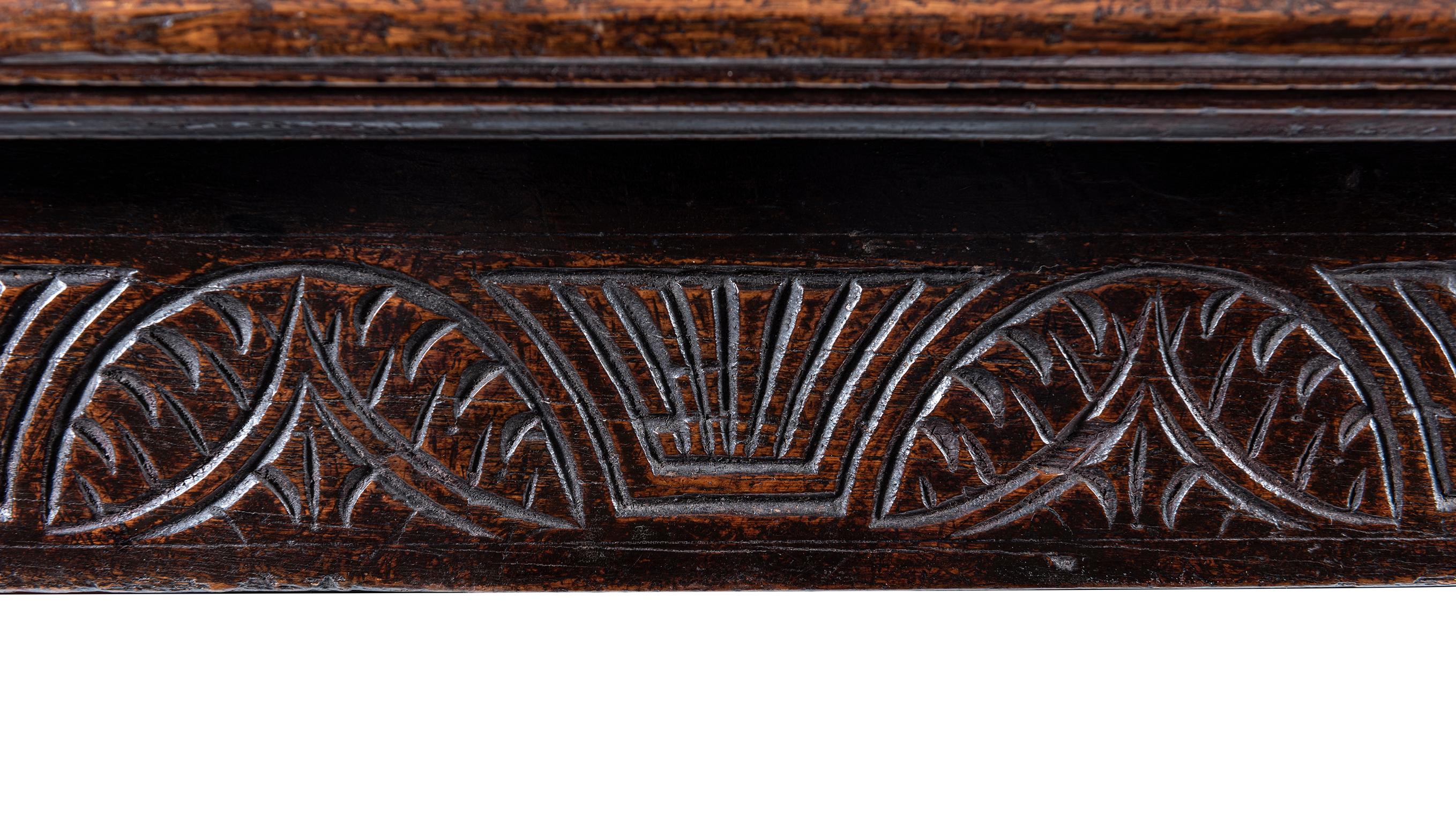 The plank top with butt ends, above a recessed and moulded apron, raised on turned legs united by an H stretcher.
The date (1656) Inscribed in relief.

Please note this piece is located in Melbourne, Australia.
Shipping times may vary based on