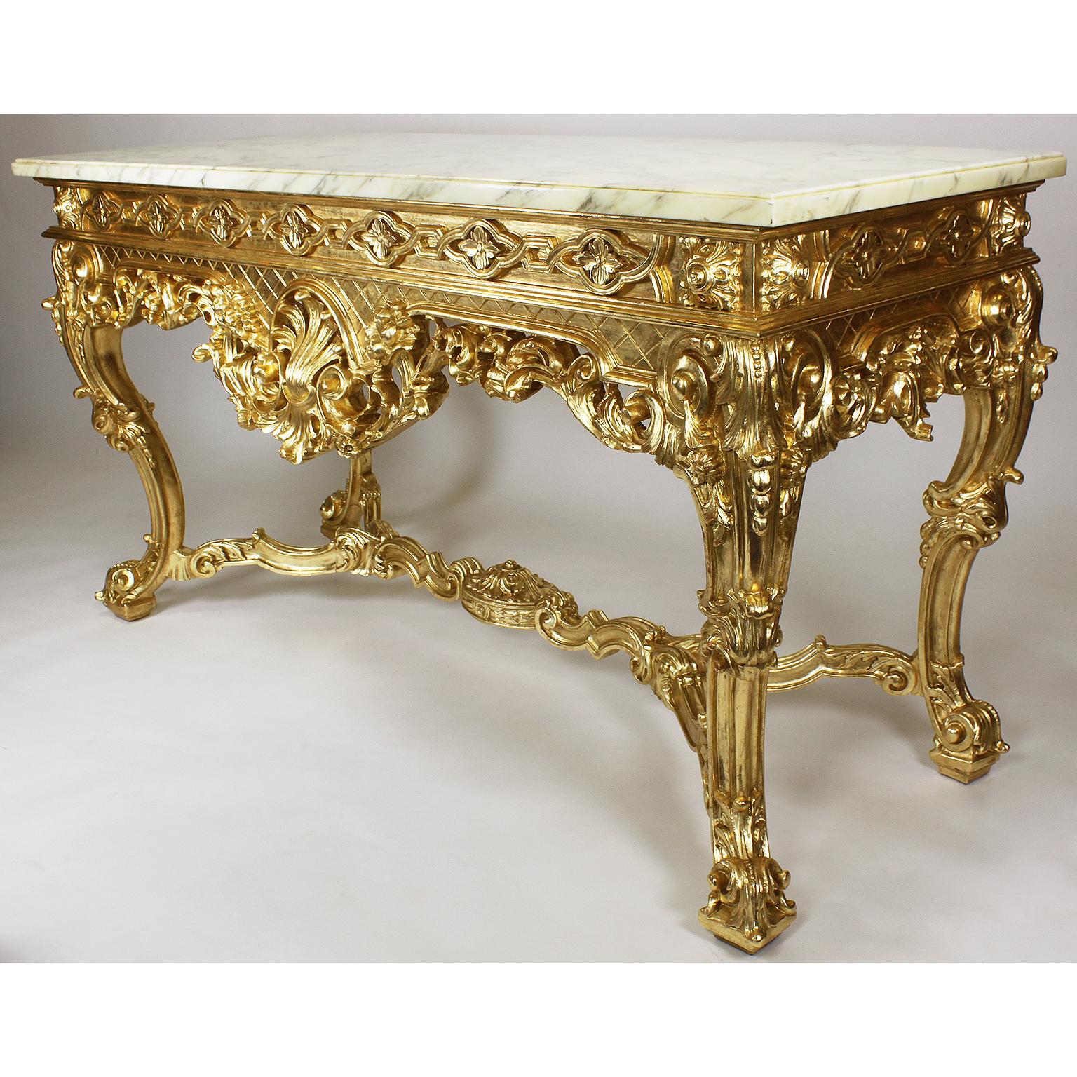An English George II style giltwood carved console table with marble top. The ornately carved apron with filigree floral, scrolls, acanthus and flowers, centered with shell-shaped leaf flanked by a pair of cornucopias filled with fruits and acorns,