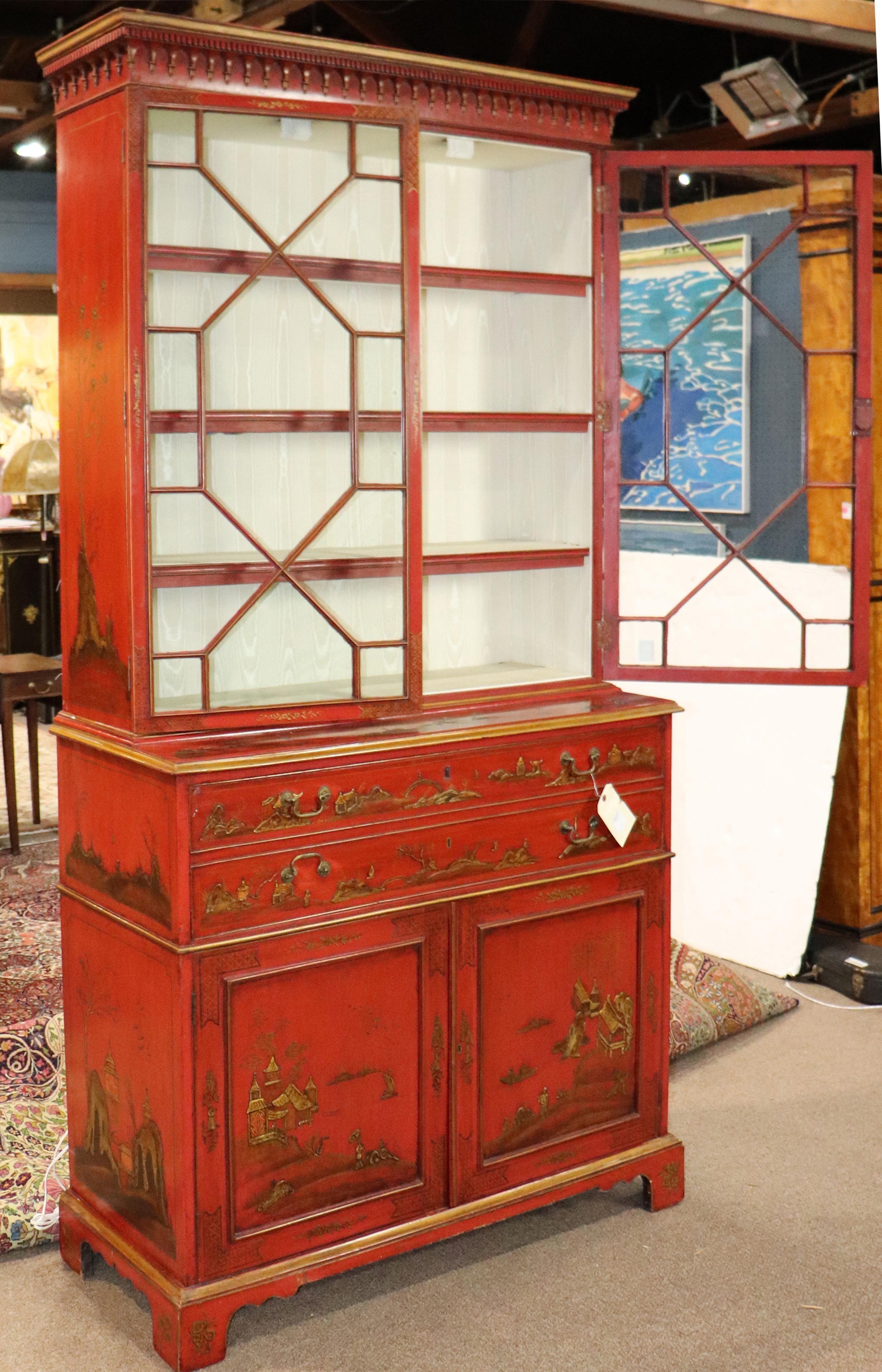 An English George III polychrome decorated secretary executed in the Chinoiserie taste, late 18th century, the superstructure with mullioned doors opening to fixed shelves above the lower case having two drawers over two doors and rising on bracket