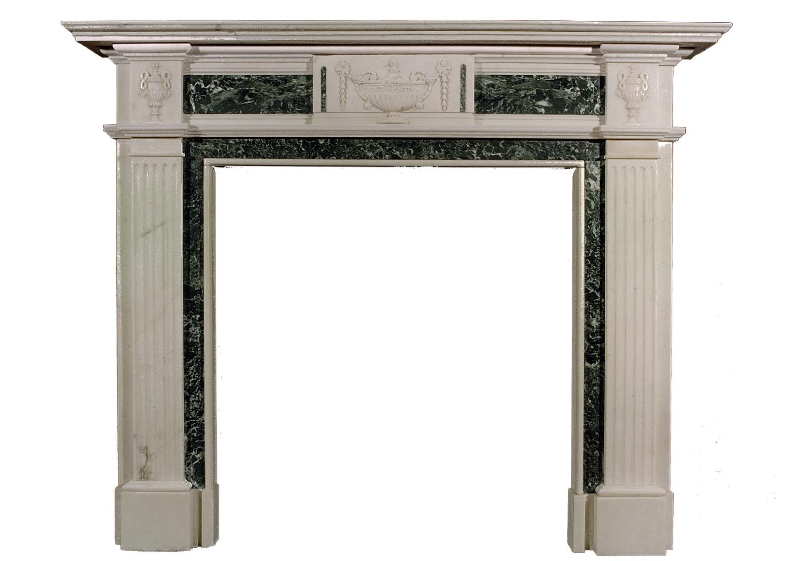 An English Georgian style Statuary and Tinos Green inlaid marble fireplace with urn to centre and bellflower drops, fluted jambs surmounted by urn side blockings. 19th century.

Shelf Width:	1590 mm      	62 ⅝