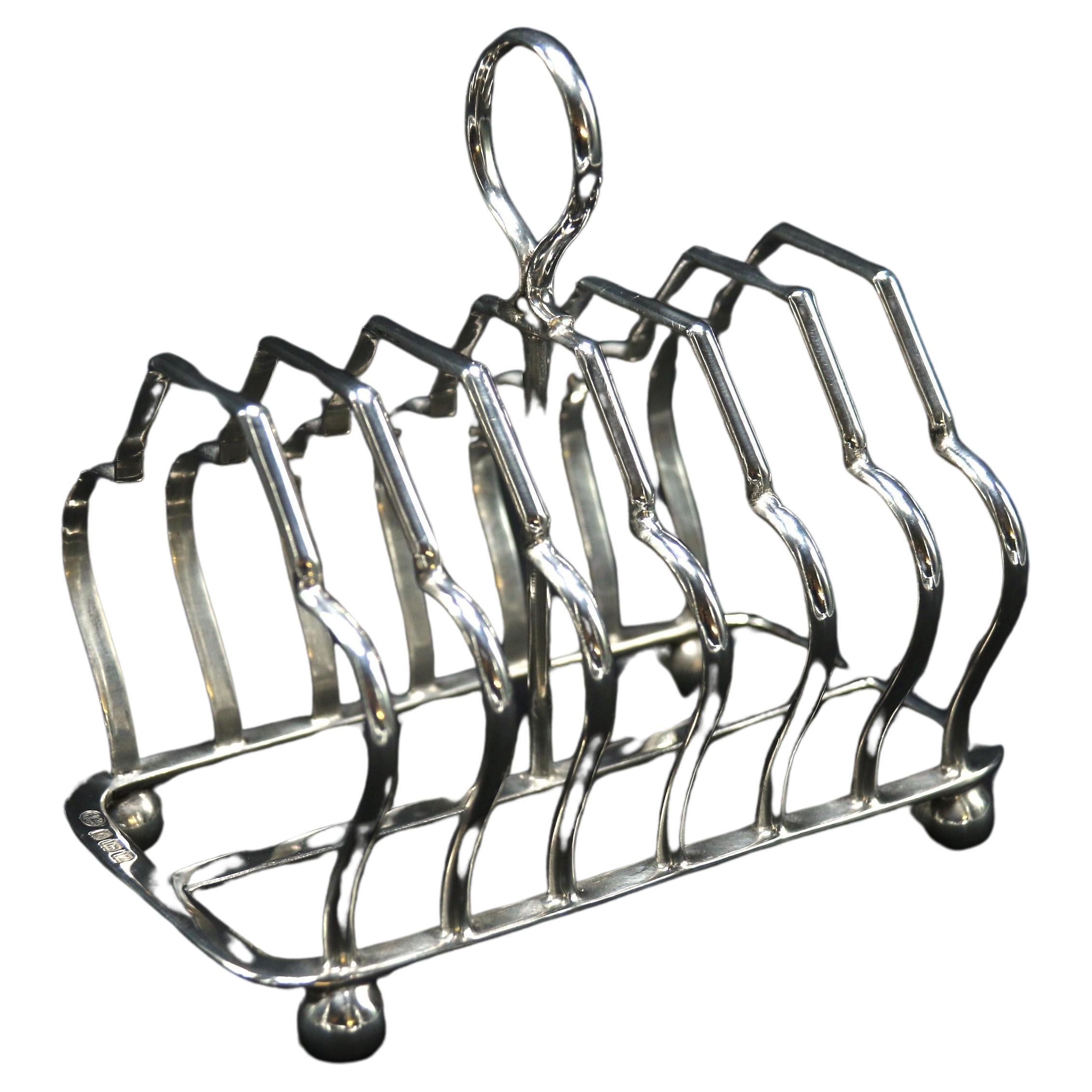 An English heavy solid silver toast rack of larger proportions 1924 - 1925 For Sale