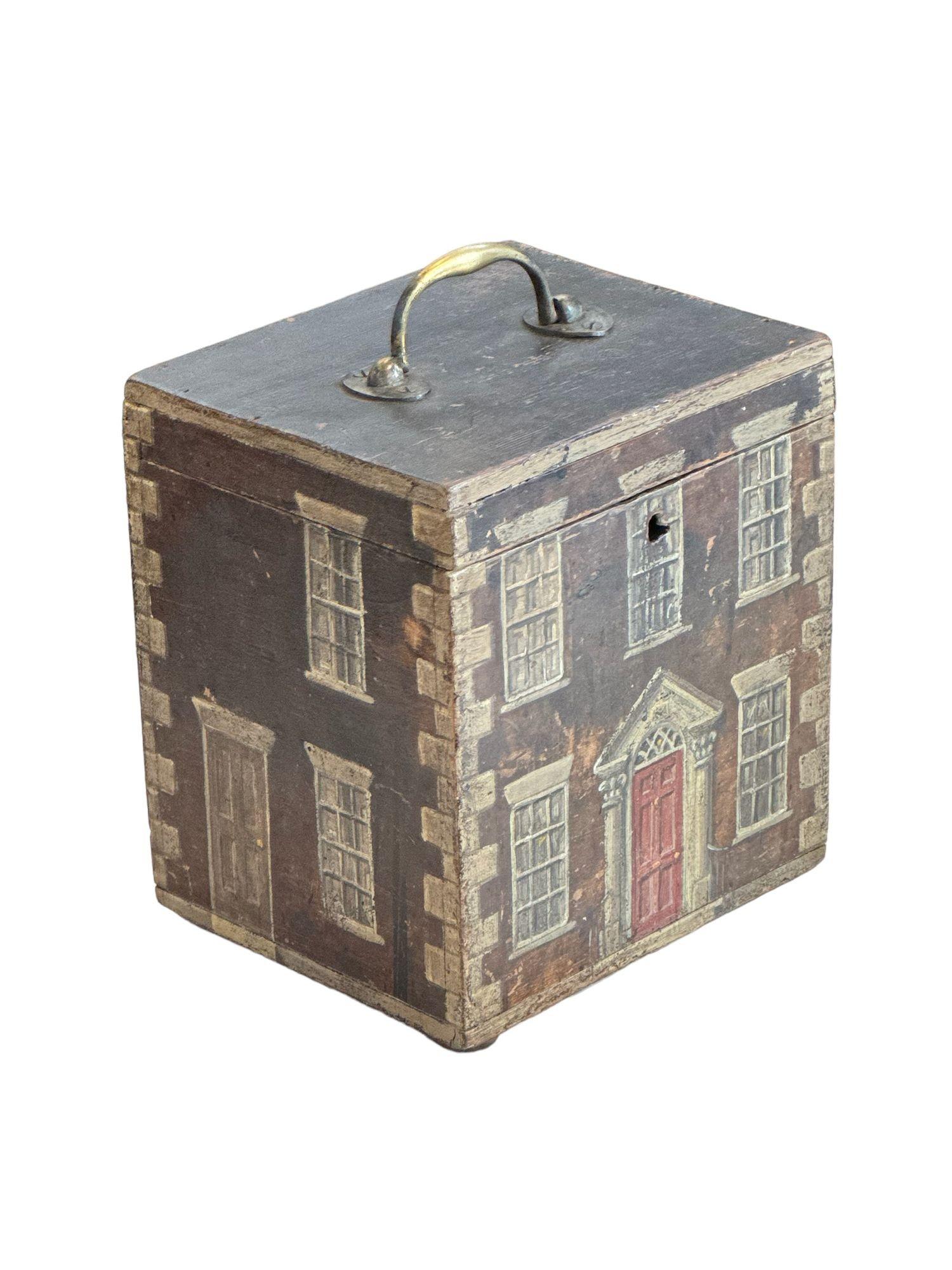 A tromp l'oeil painted box in the manner of a georgian house. H. 10inches, W. 8 inches, D. 6.75 inches
Good condition, but lacking lock.