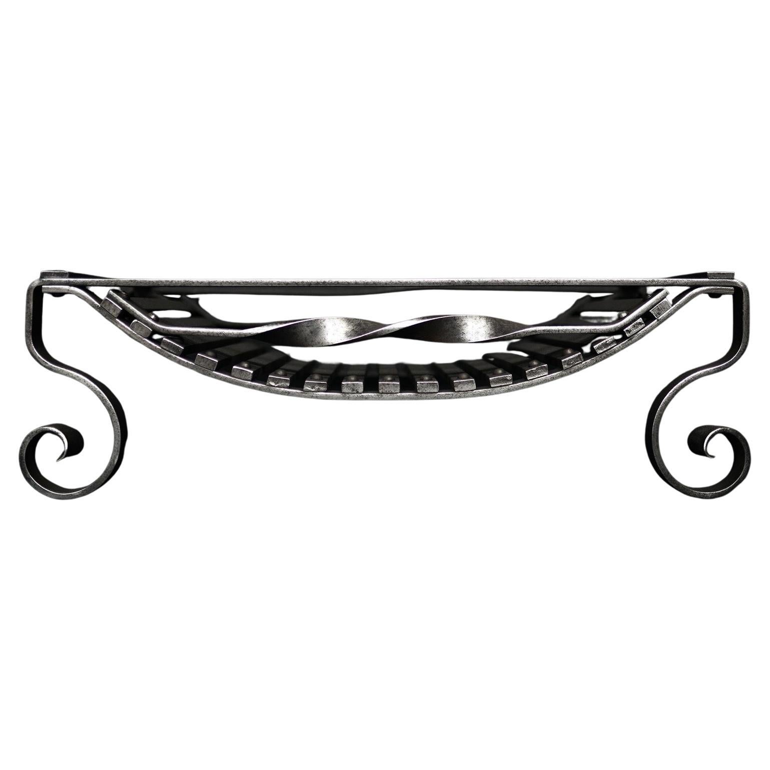 An English Polished Wrought Iron Firegrate