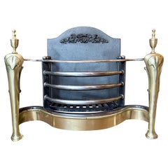 An English Queen Anne Style Wrought Iron And Brass Fire Grate