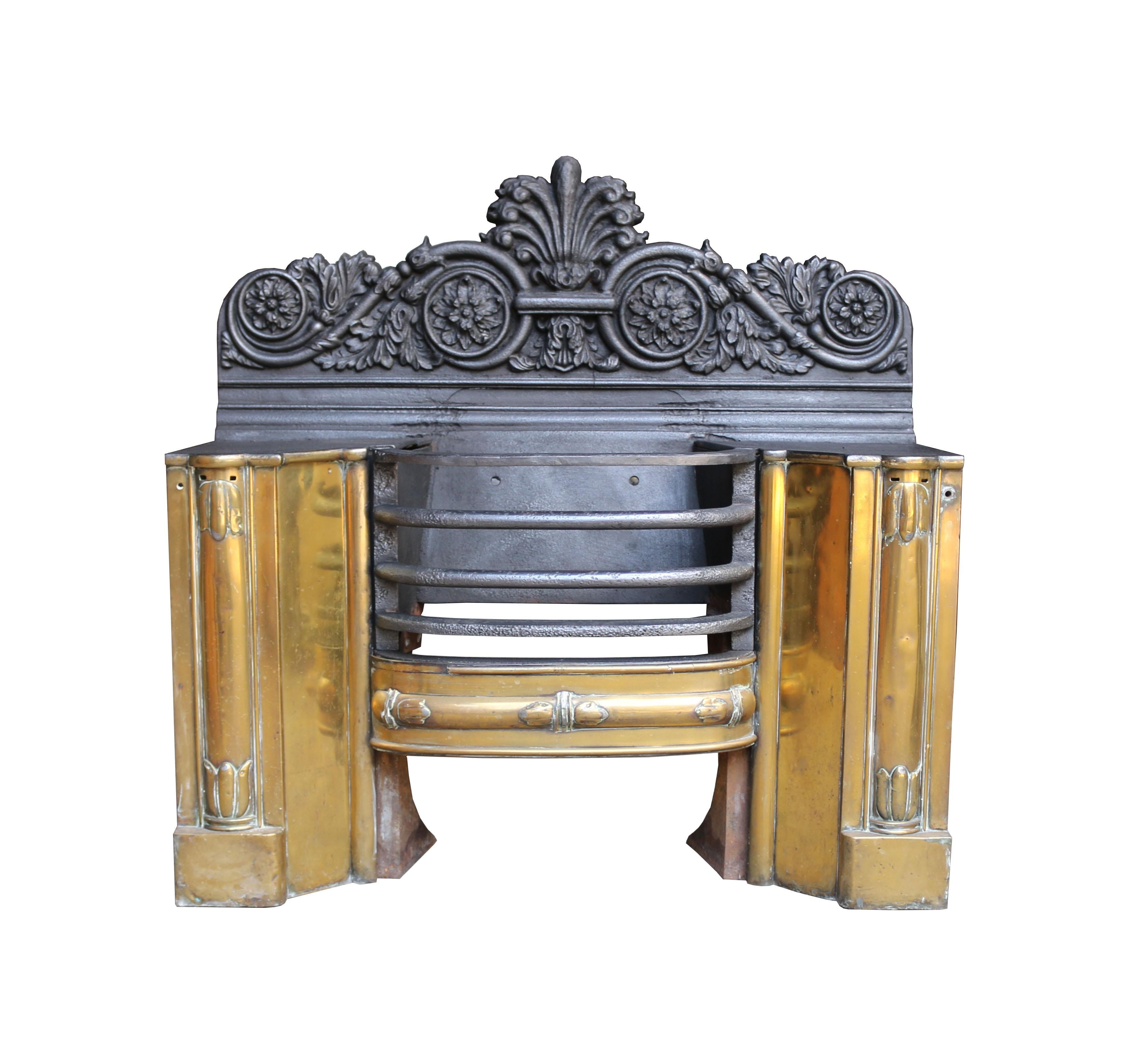 An unusual cast iron hob grate, the front faces covered with polished brass.