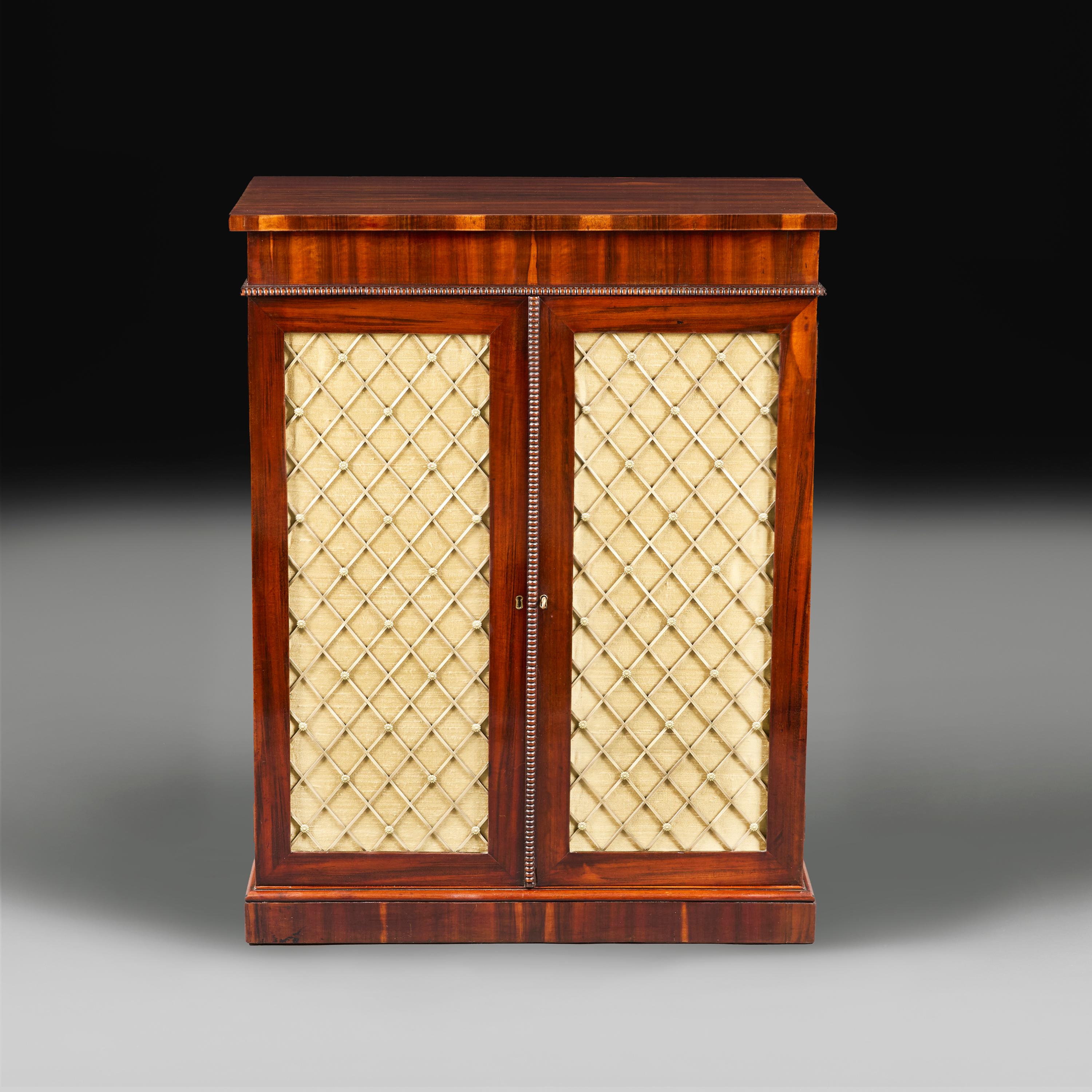 England, circa 1820

A fine early 19th century cabinet, with finely figured timber, with yellow silk panels with brass grills to the front, the interior with single shelf.

Height     90.00cm.

Width       71.00cm.

Depth       40.00cm.
