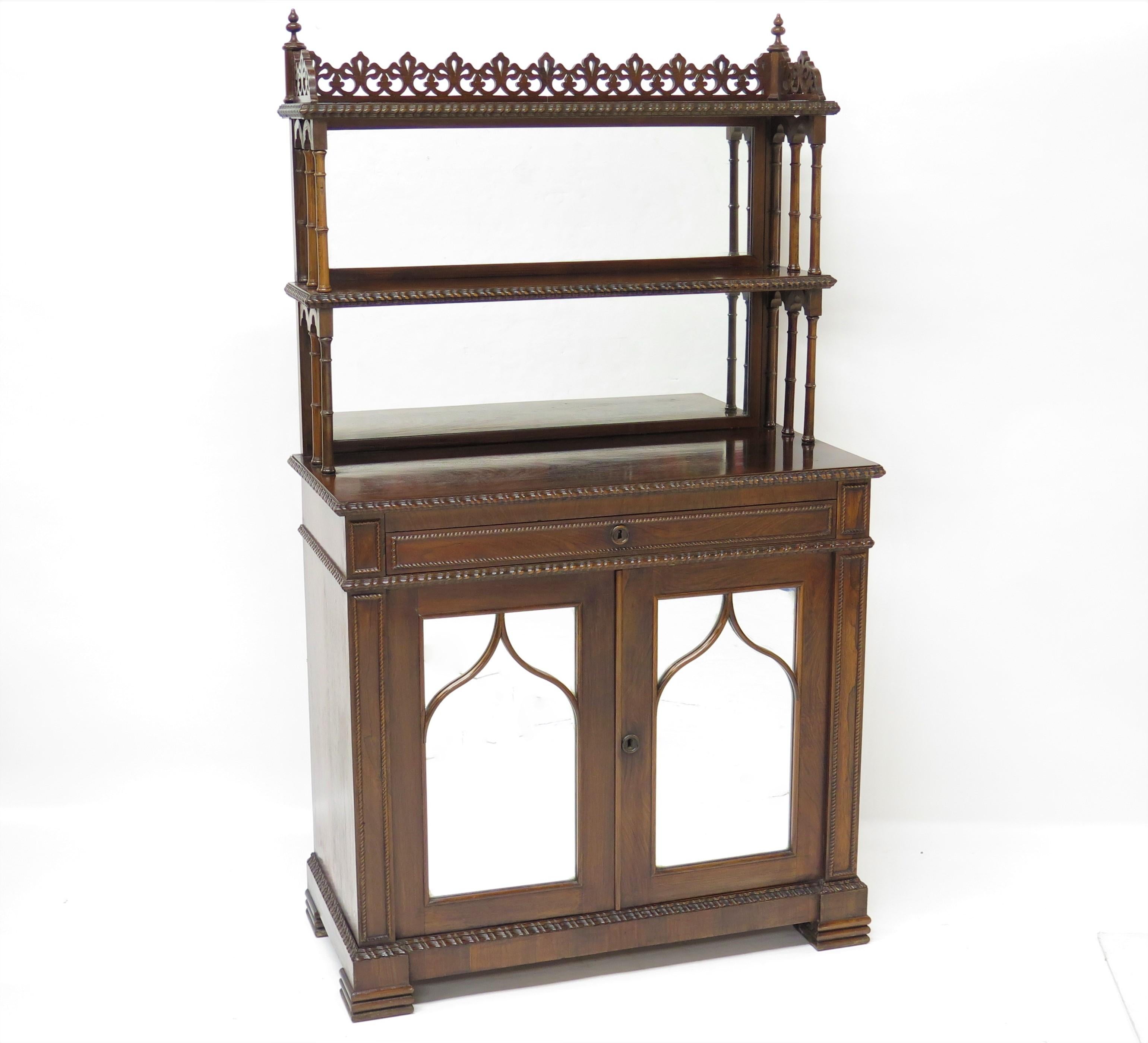 An English regency rosewood chiffonier bookcase or bar decorated in the gothic manner. England. Circa 1820