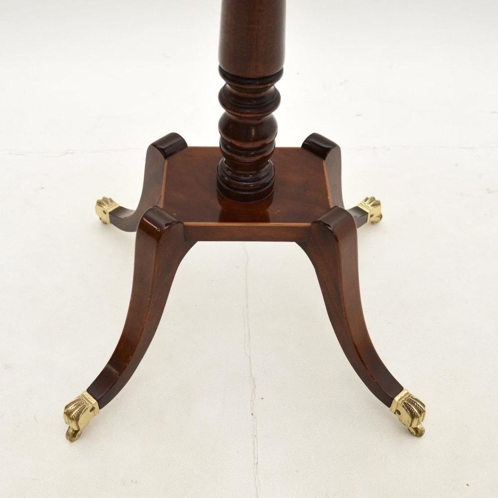 A Stunning English Regency inlaid mahogany and satinwood game table.  The beautifully designed and high-quality table is inlaid with a light and dark wood chess board and has a cross banded edge.  The base is a beautifully turned baluster center