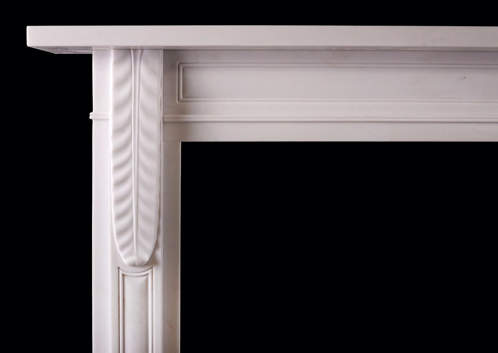 A understated English Regency Style Statuary marble fireplace. The panelled jambs with delicate brackets above. The panelled frieze surmounted by plan shelf above. Reproduction, a copy of a period piece. 

Shelf Width: 1528 mm 60 ?