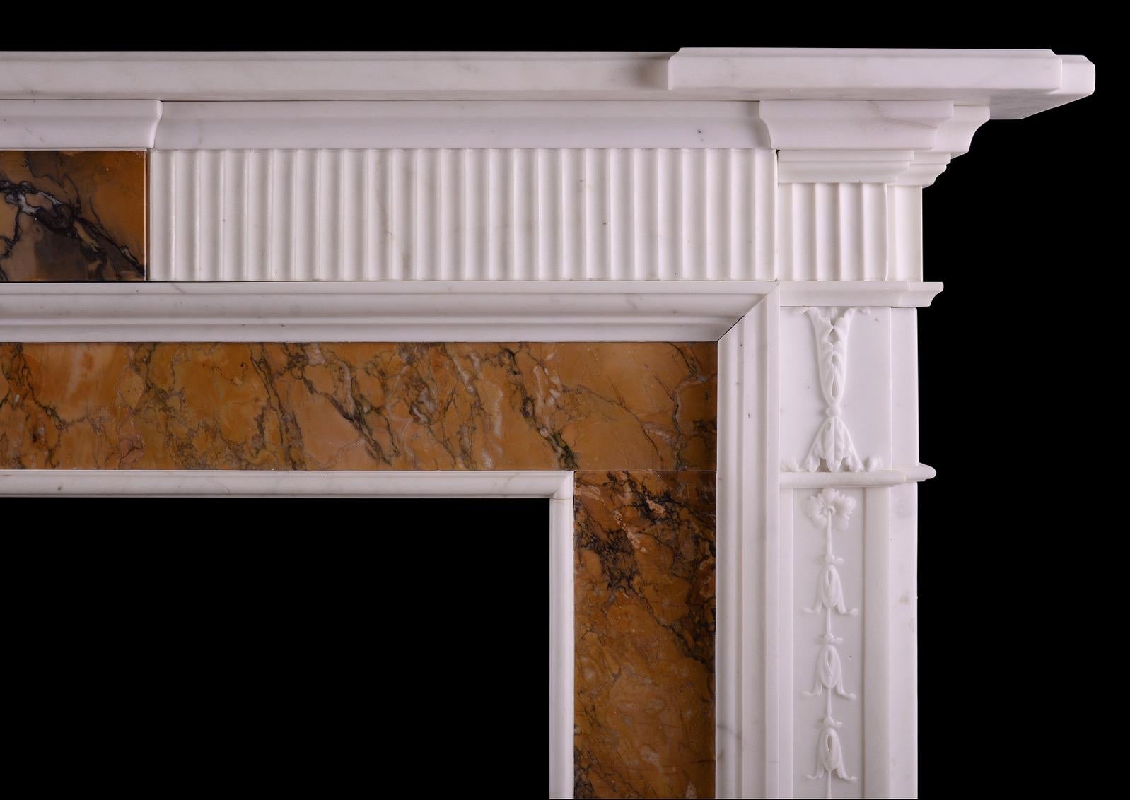 An English Georgian Statuary marble fireplace with Italian Siena inlay. The jambs with carved bell drops and foliage, with Siena inlay to ingrounds. The reeded frieze with Siena centre block, surmounted by moulded shelf. English, late 18th