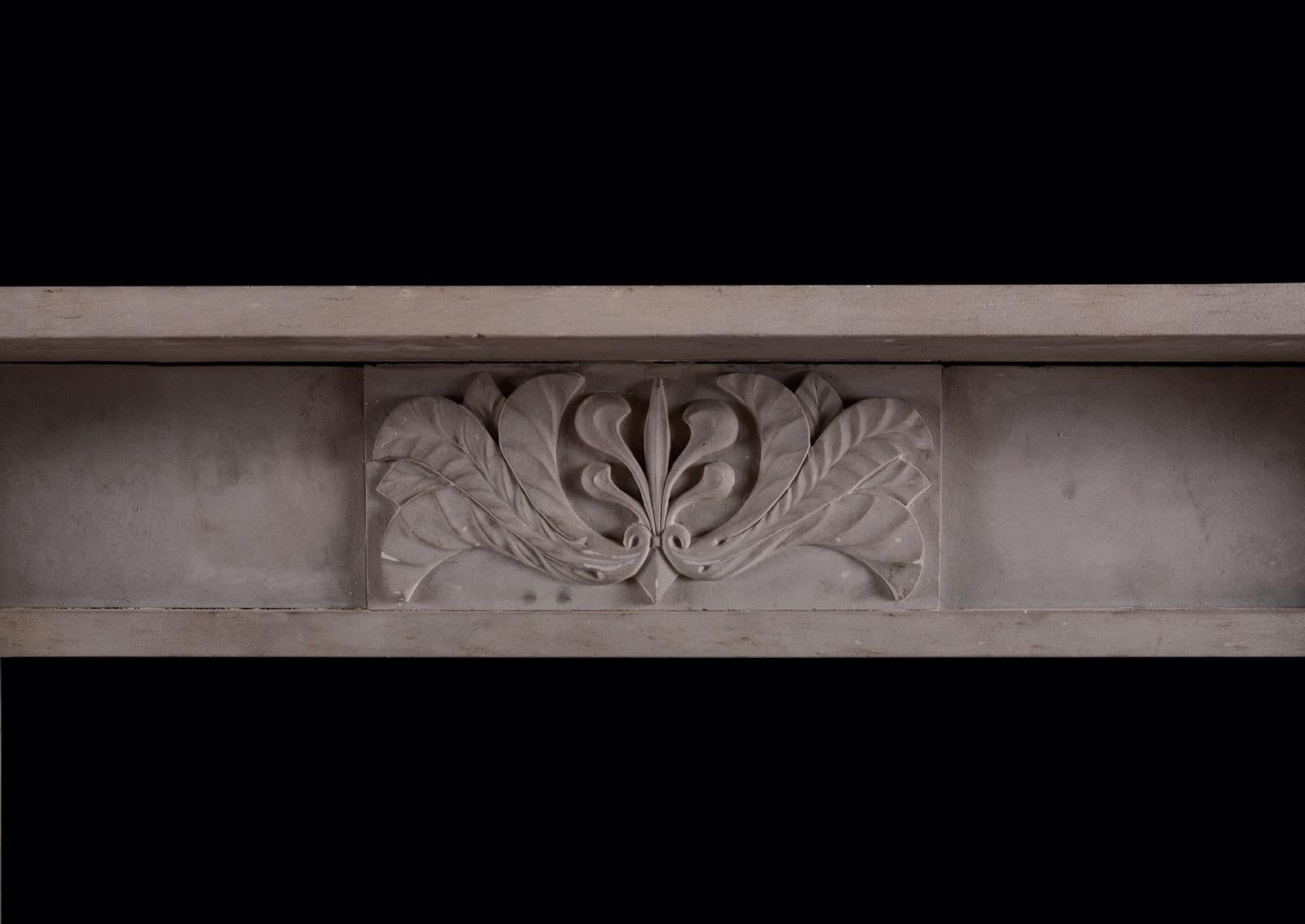 An English stone fireplace in the Regency style. The tapering jambs surmounted by shaped end blocks carved with palmettes. The frieze with centre block carved with foliage. Plain shelf above. (Photo prior to full restoration.)

Shelf width: 1741