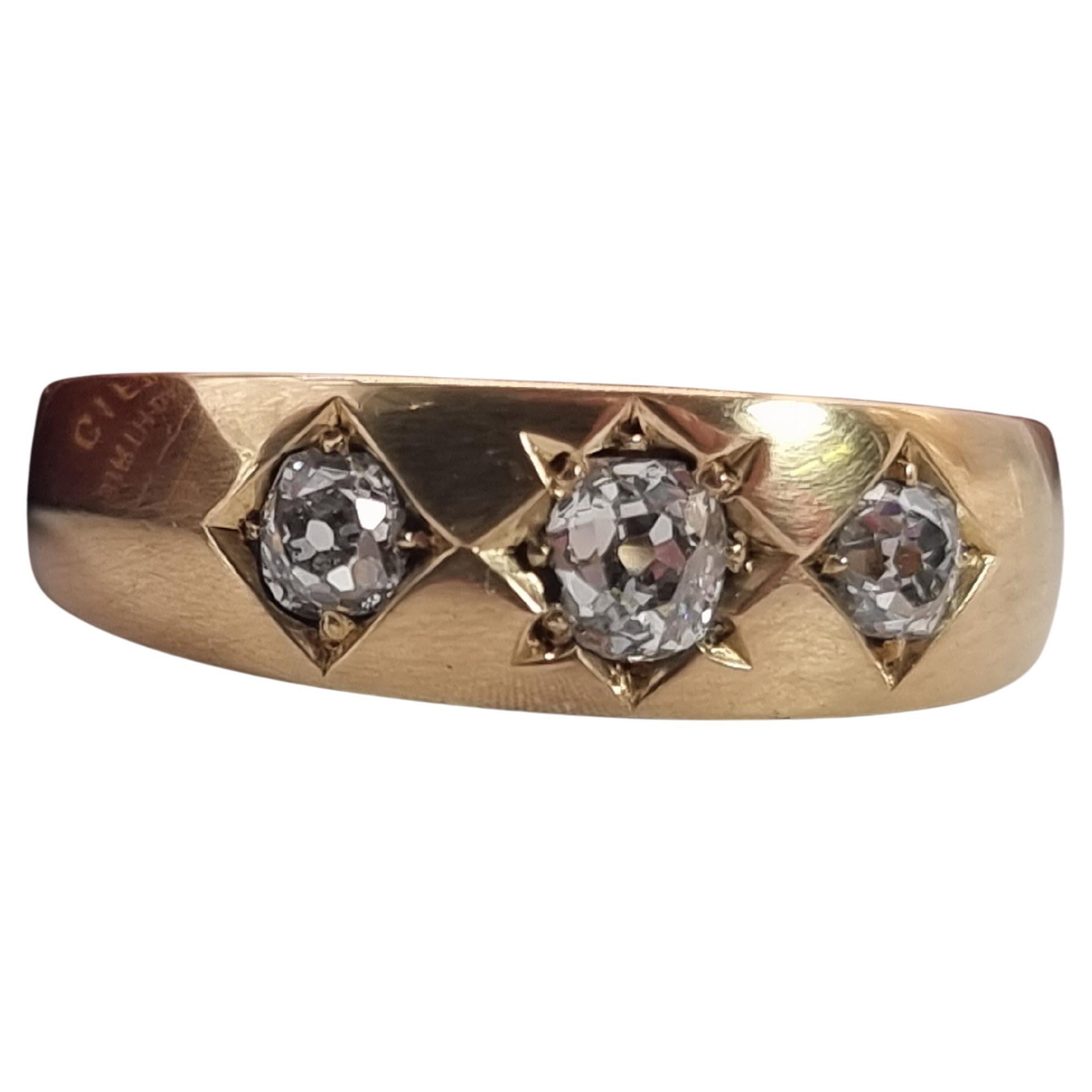 An English Victorian heavy 18ct gold and diamond three stone ring dated 1870