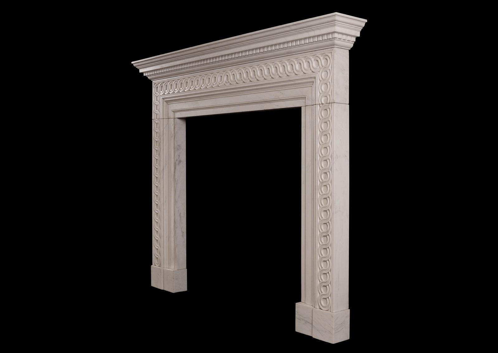 An English white marble fireplace. The frieze and jambs with carved guilloche pattern throughout, surmounted by moulded shelf with carved dentils. English, based on a late Georgian design. Modern. 

Shelf Width: 1580 mm 62 ¼