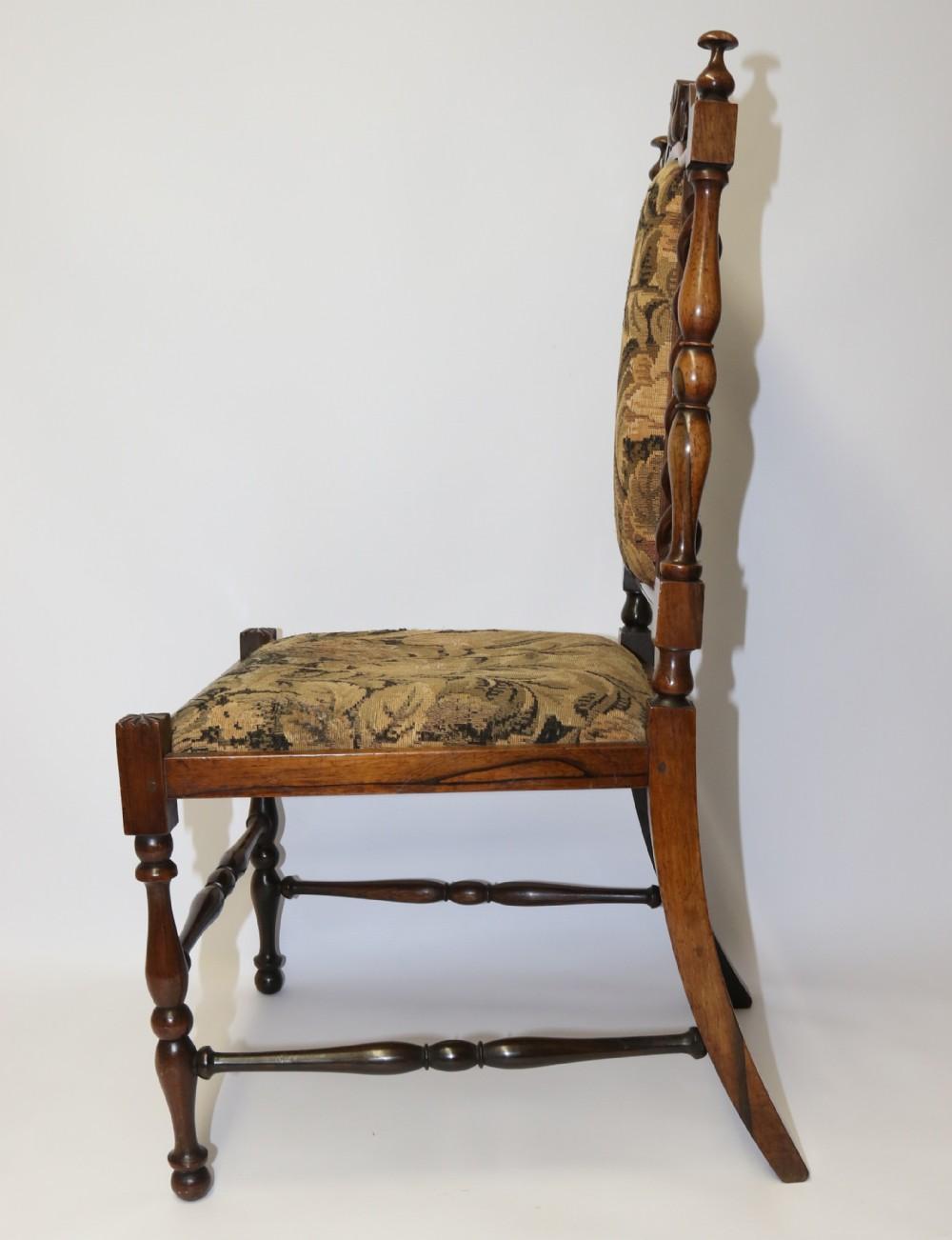 This superb rarity was made circa 1835. It is constructed in solid figured rosewood made to a delicate and ornate design incorporating turned legs and stretchers with a drop in seat and the back panel upholstered in worn but original tapestry