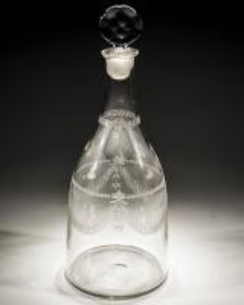 A Continental magnum decanter of tapered shape engraved with swags

Portugal, 1785.