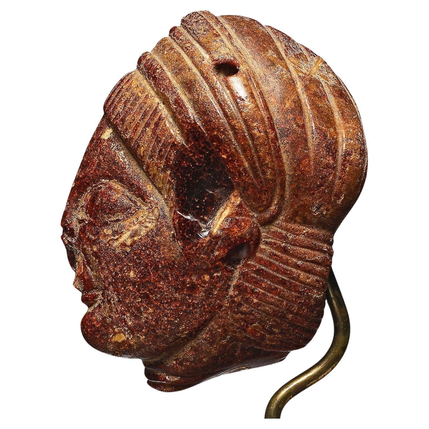 An Etruscan Amber Head Pendant. Etruria, circa 5th century B.C. For Sale