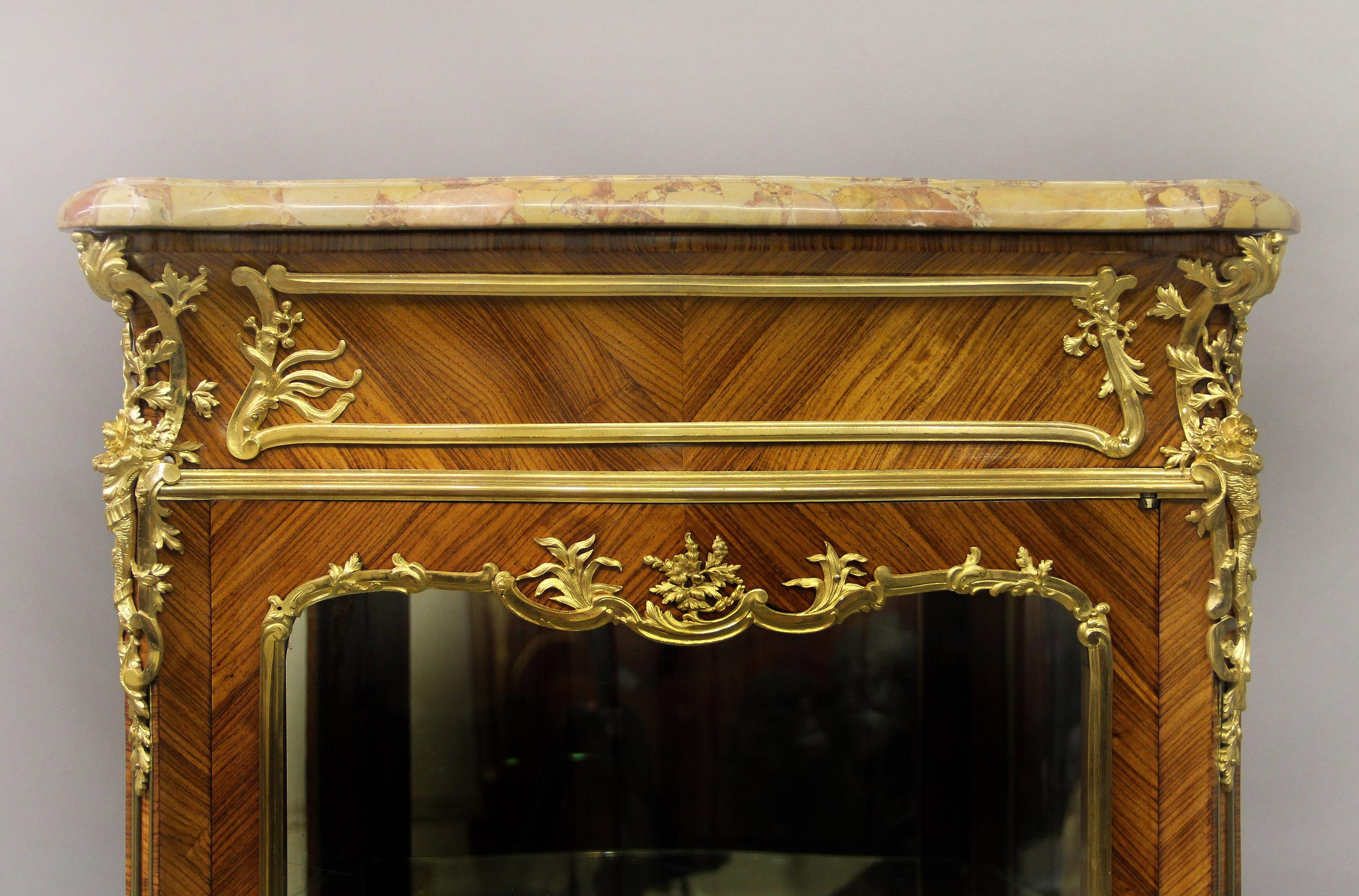 An excellent late 19th century Louis XV style gilt bronze mounted vitrine by Joseph Zwiener

Joseph Zwiener

The serpentine-shaped brèche d’ alep marble top above a single centered glass door, flanked to each side by a conforming panel, the
