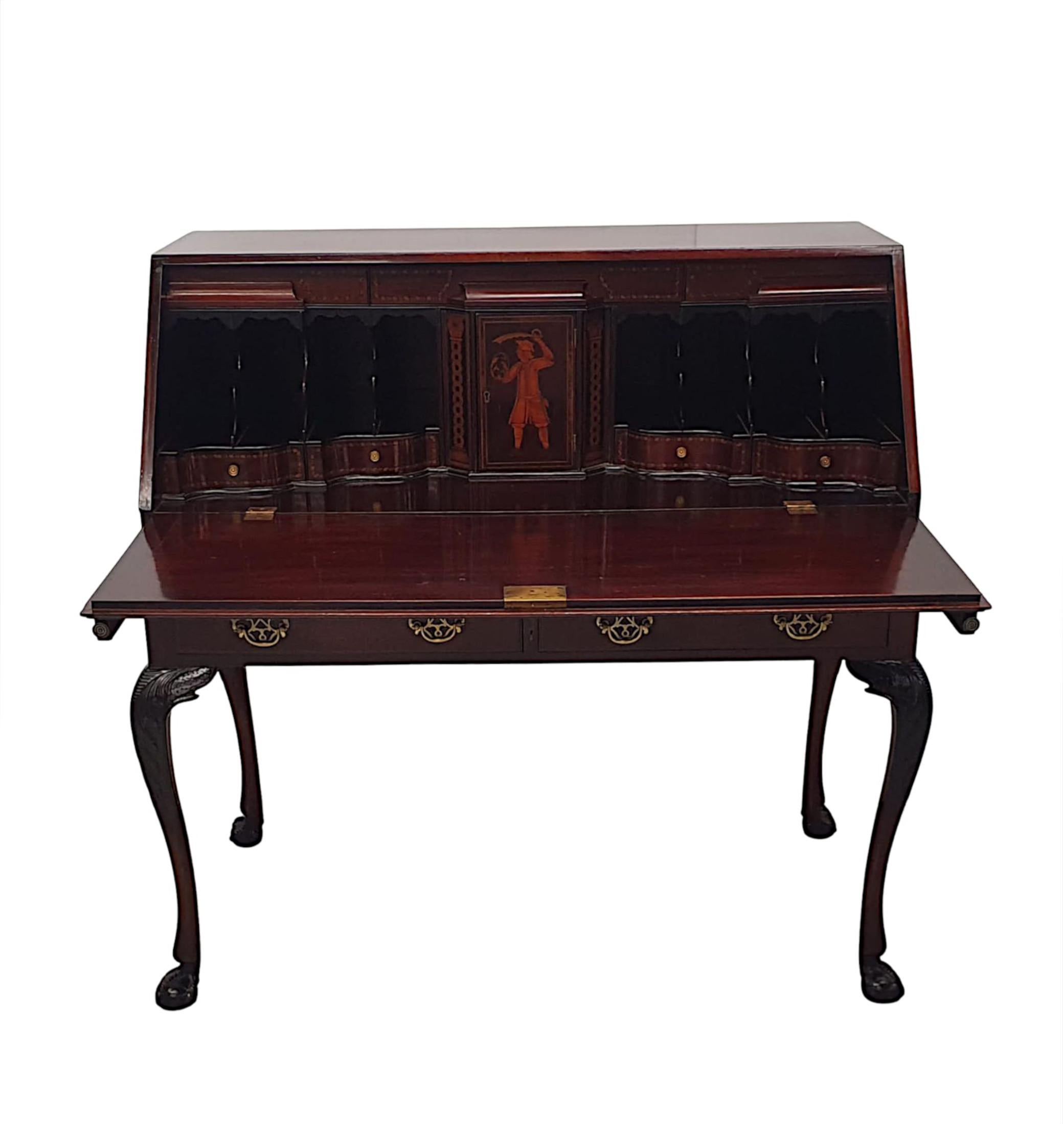 An exceptional 19th Century Irish, finely carved and richly patinated mahogany fall front bureau by Butler of Dublin.  The moulded fall front opens forwards revealing a writing surface which rests on two pull out slide supports and a fitted interior