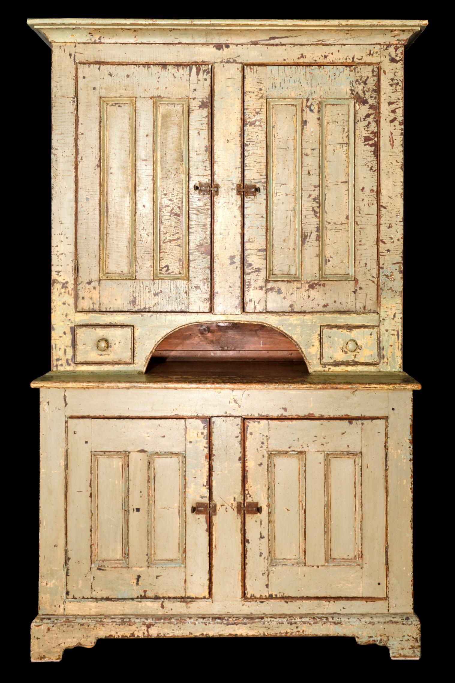 An early 19th century Georgian-inspired painted pine step-back cupboard of outstanding proportions & form.
Constructed in two parts, with both the upper section & base showing traditional pegged construction & hand forged iron nails. 
The upper