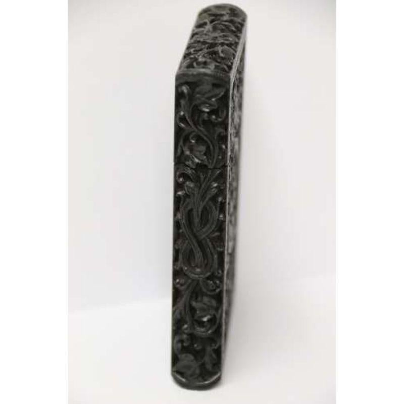 An exceptional Indian Raj Period carved ebony calling card case.

This superb and rare example is of the finest quality of workmanship. It is made from two pieces of solid ebony which have been hollowed and fitted to make a calling card case. The