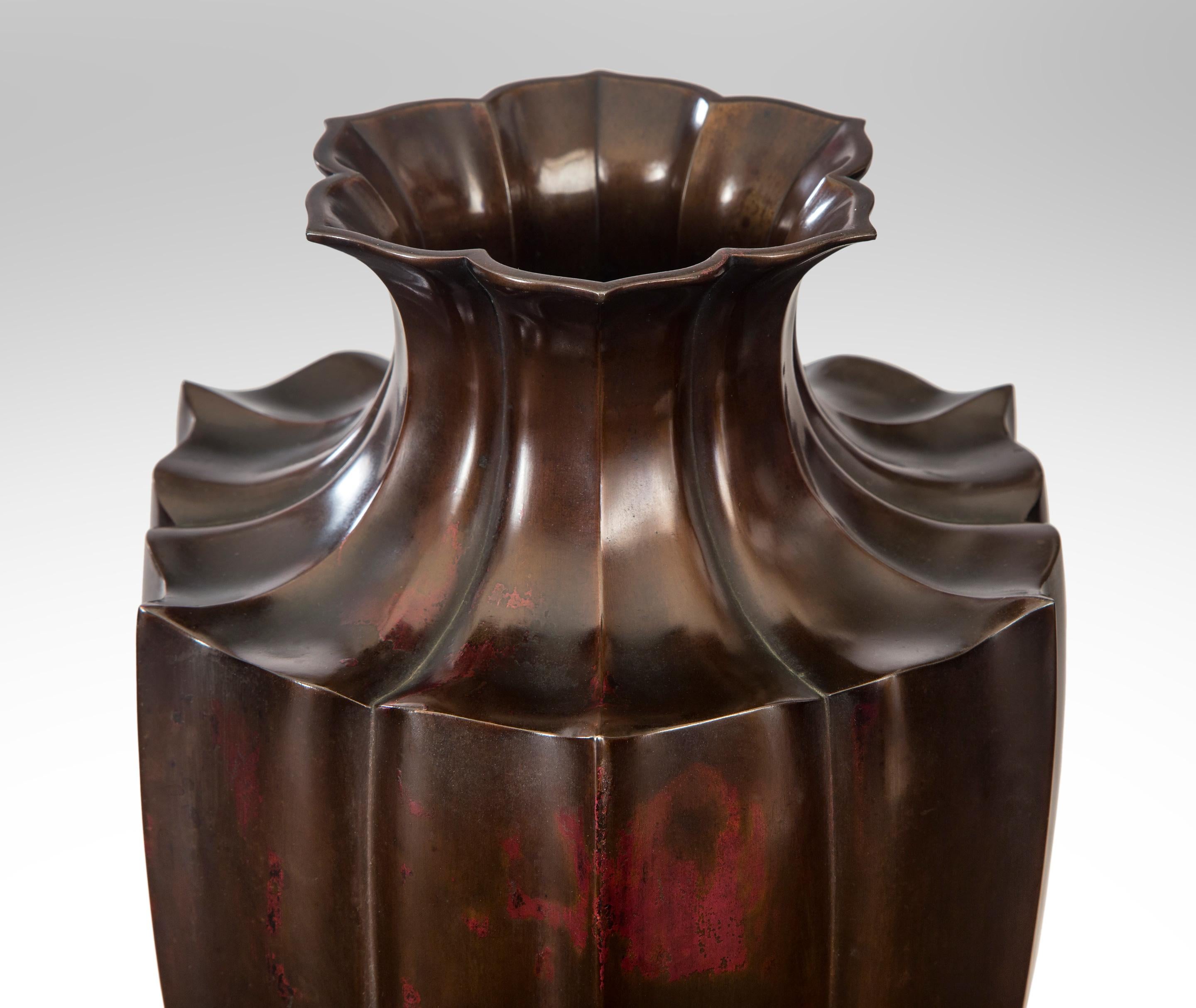 An exceptional Japanese patinated bronze Lotus flower vase.
Edo or Meiji 19th century
The complex form and significant scale of this extraordinary, tall vase is an important example of Japanese metal work at its finest. The hexagonal lobed neck