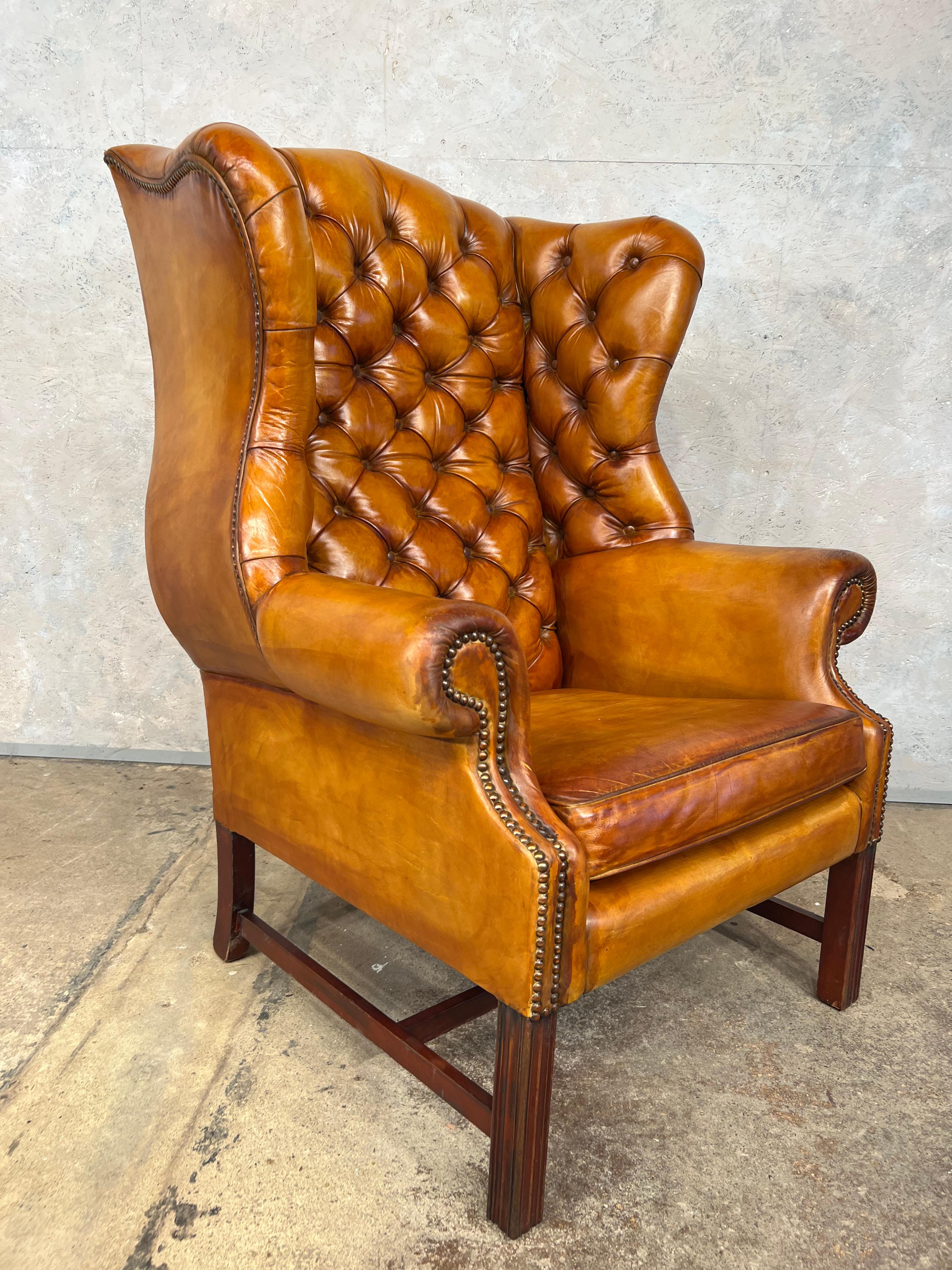 An exceptional leather chesterfiled wing back chair made by Wade vintage mid century

An beautiful light tan colour with a fantastic patina and finish. A generous sized wingback chair with a wide back, resting on fine Georgian straight feet, in