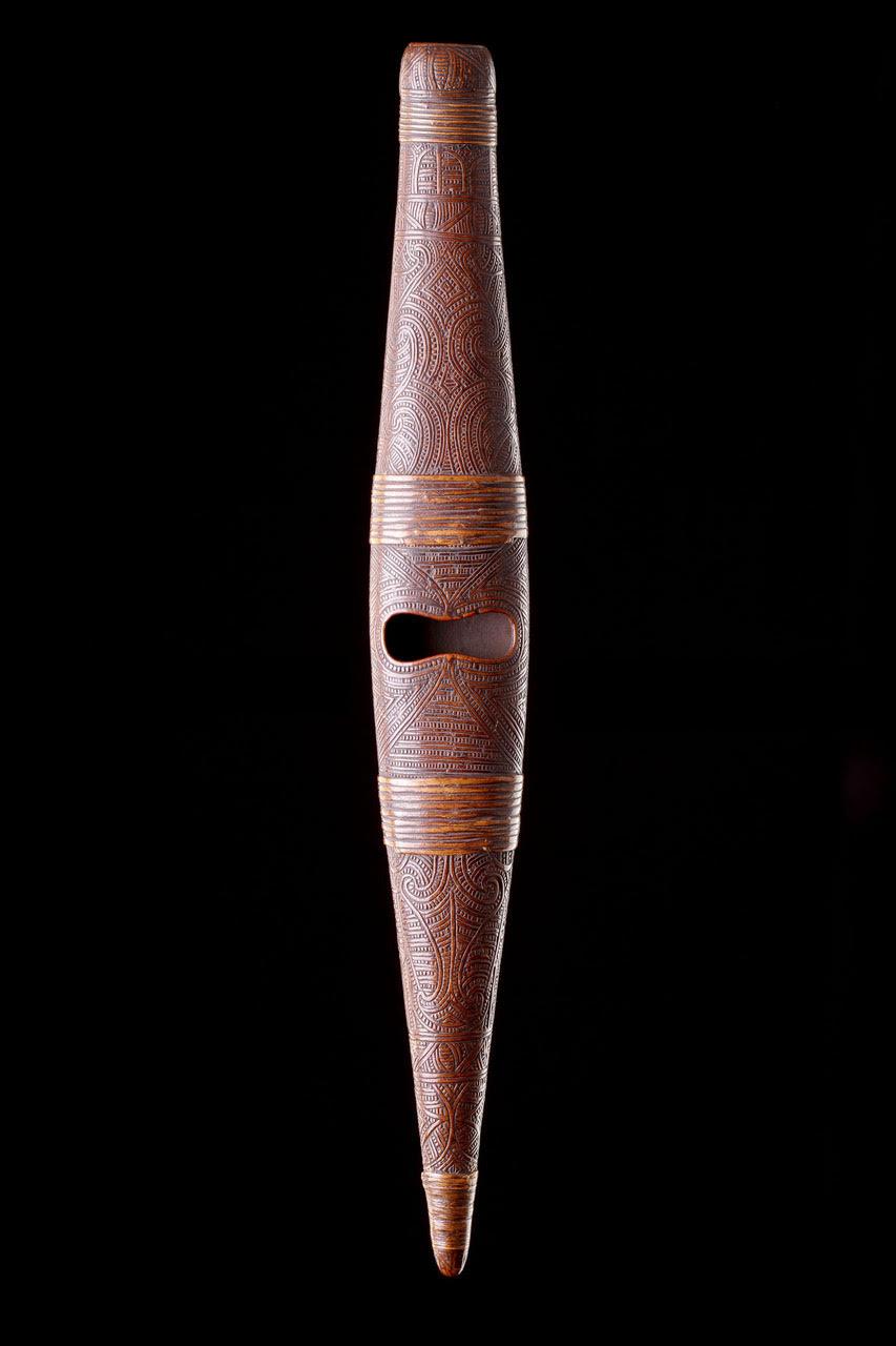 An Exceptional New Zealand Māori Bugle-Flute ‘Pu Turino’
With soft and shallow surface decoration profusely carved with a dynamic scrolling motif made of two sections bound together with original and complete ‘Kiekie’ vine roots at four points
The