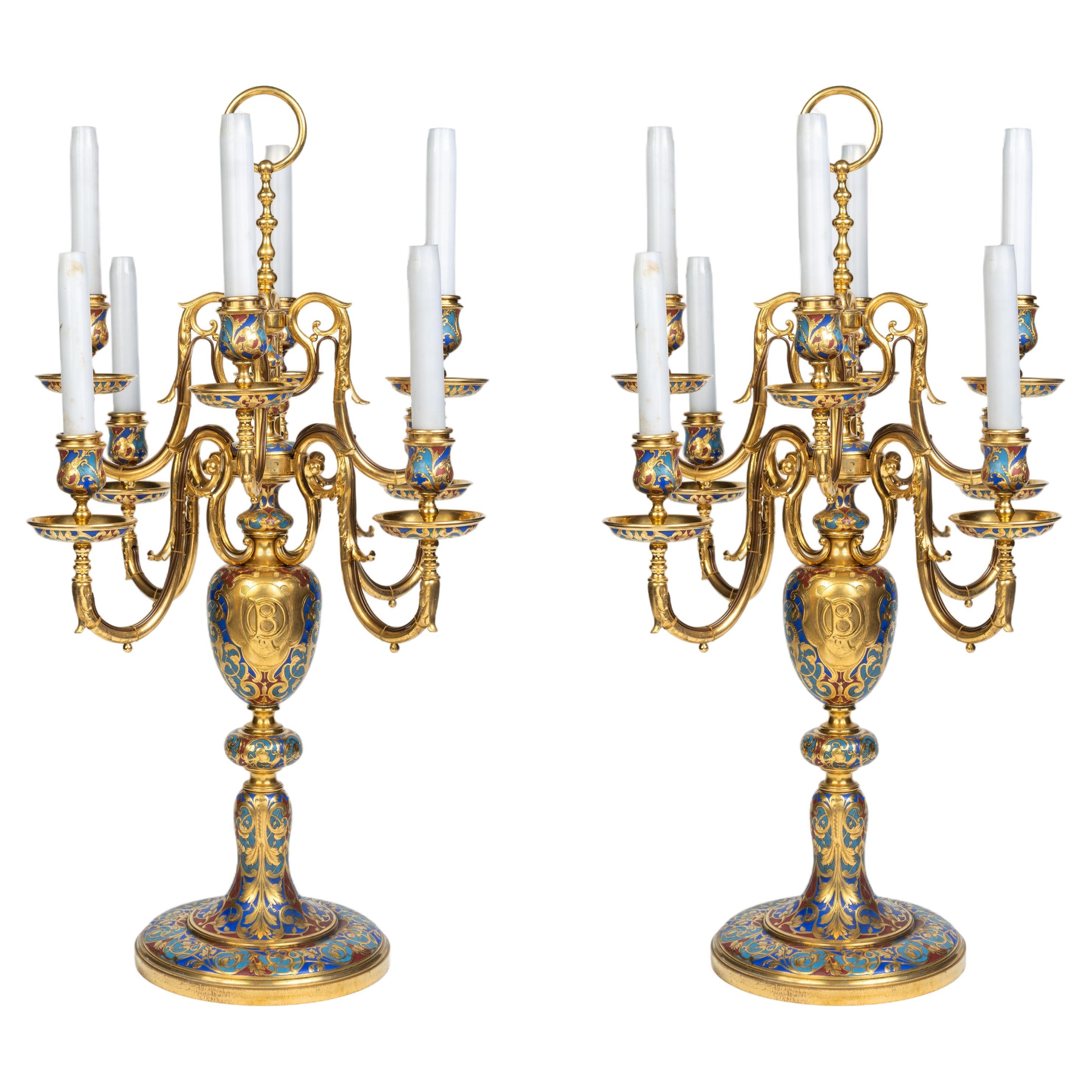 Une paire exceptionnelle de candélabres en émail champlevé et bronze doré de Sevin & Barbedienne