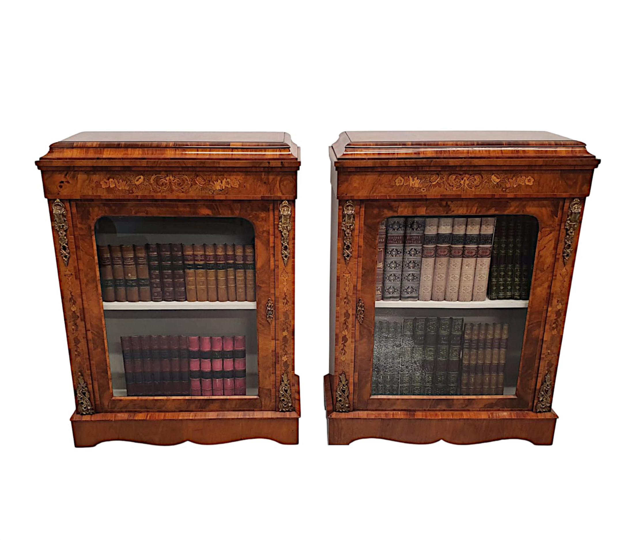 An exceptional pair of rare 19th century richly patinated walnut and tulipwood pier cabinets or bookcases, finely hand carved, cross banded, ormolu mounted and marquetry inlaid throughout. The well figured moulded top of rectangular form above