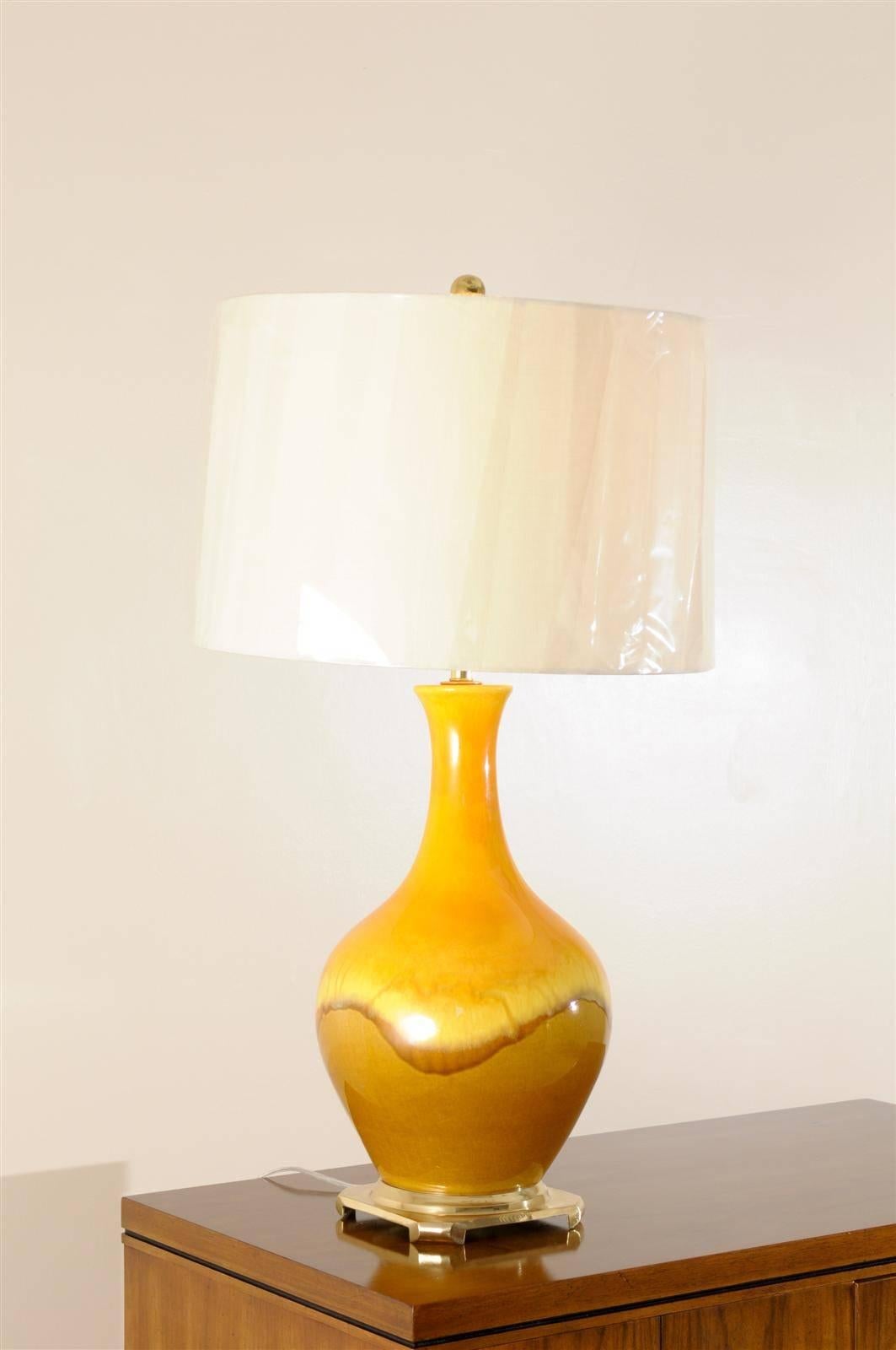 These magnificent lamps have been professionally restored and are shipped as photographed and described, complete with new shades, harps and finials.

A fabulous pair of large-scale vintage ceramic and brass lamps, circa 1970s. The yellow ochre and