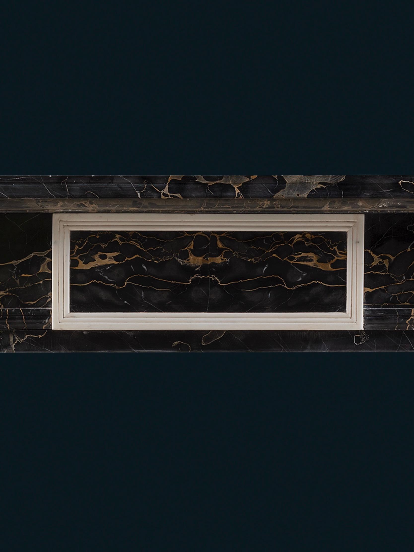 Carved An Exceptional Regency Style Chimneypiece in Portoro Nero & Statuary Marbles For Sale