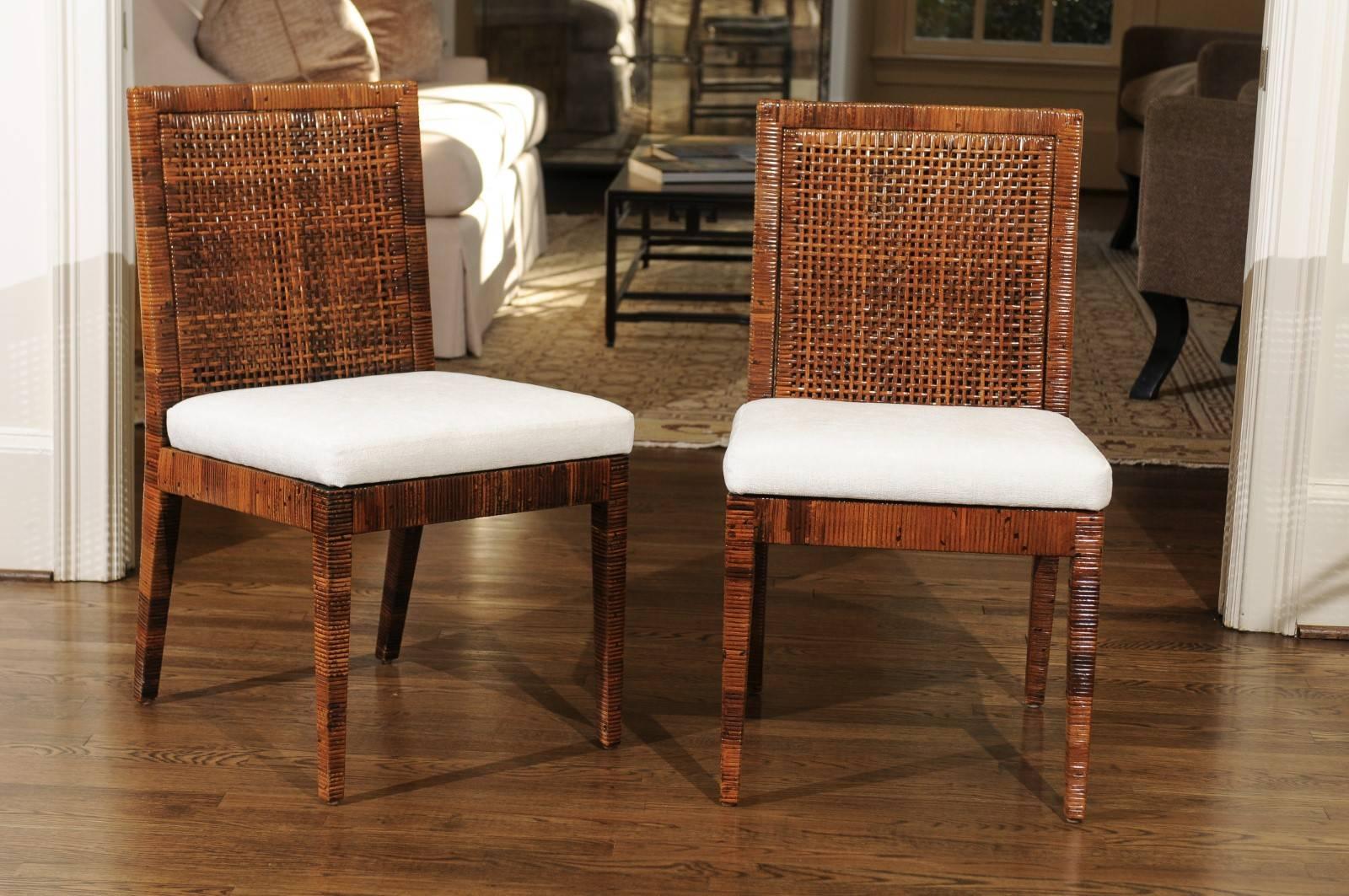 A stunning restored set of eight (8) Billy Baldwin style dining chairs by Bielecky Brothers, circa 1975. Stout hardwood Parsons form painstakingly hand-wrapped in cane with double cane back panels. Rich mellowed Caramel finish with burnished Ebony