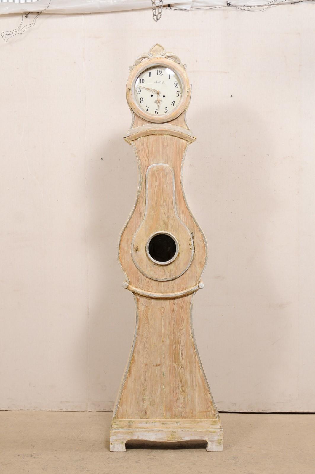 A Swedish wood carved Mora floor clock from the 19th century. This antique Mora clock from Sweden is a very nice clock; it is taller than the typical Mora clock and features details more closely associated with a Fryksdahl clock. This grandfather