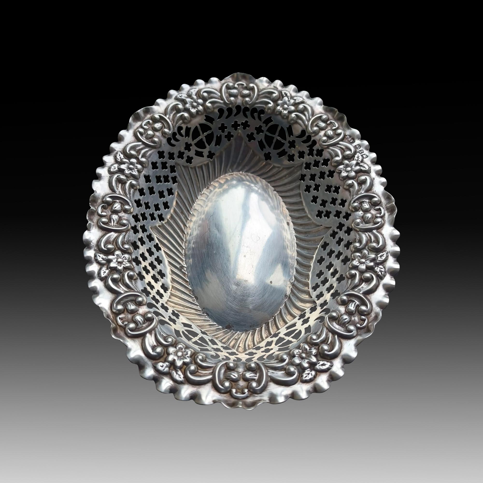 An exceptional Victorian Silver Bonbon Dish with Pierced Sides, with its intriguing history and delicate design masterfully crafted by the revered silversmiths Deakin & Francis, Circa 1897. Deakin & Francis, a name synonymous with excellence, is the