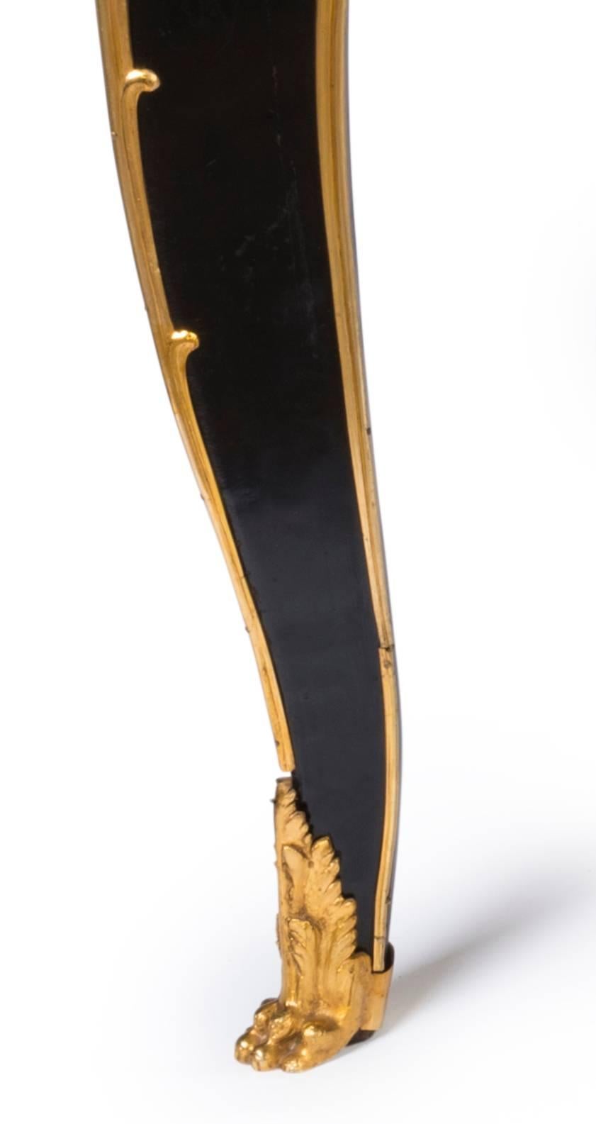 An exceptionally fine 19th century black lacquered and ormolu-mounted Bureuplat in the style Jacques Dubois, the tooled red leather writing surface to graduated edge and leaf corner clasps over straight fronted frieze of three framed japanned
