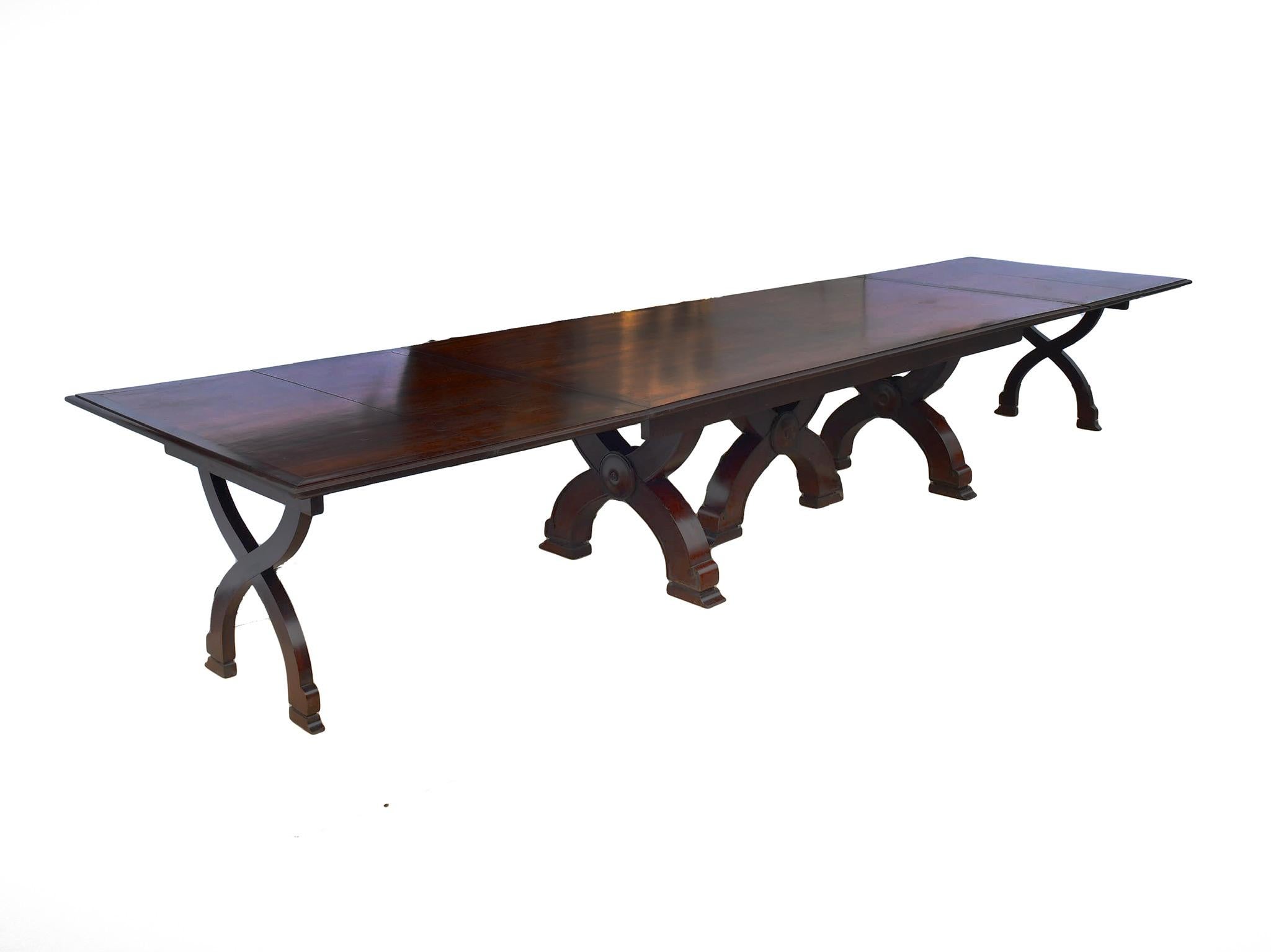 An exceptionally grand and very large and versatile Napoleon III mahogany table that could serve as a conference or dining room table. It comes with a base, four middle section extension leaves and four end leaves. It has three options: standard