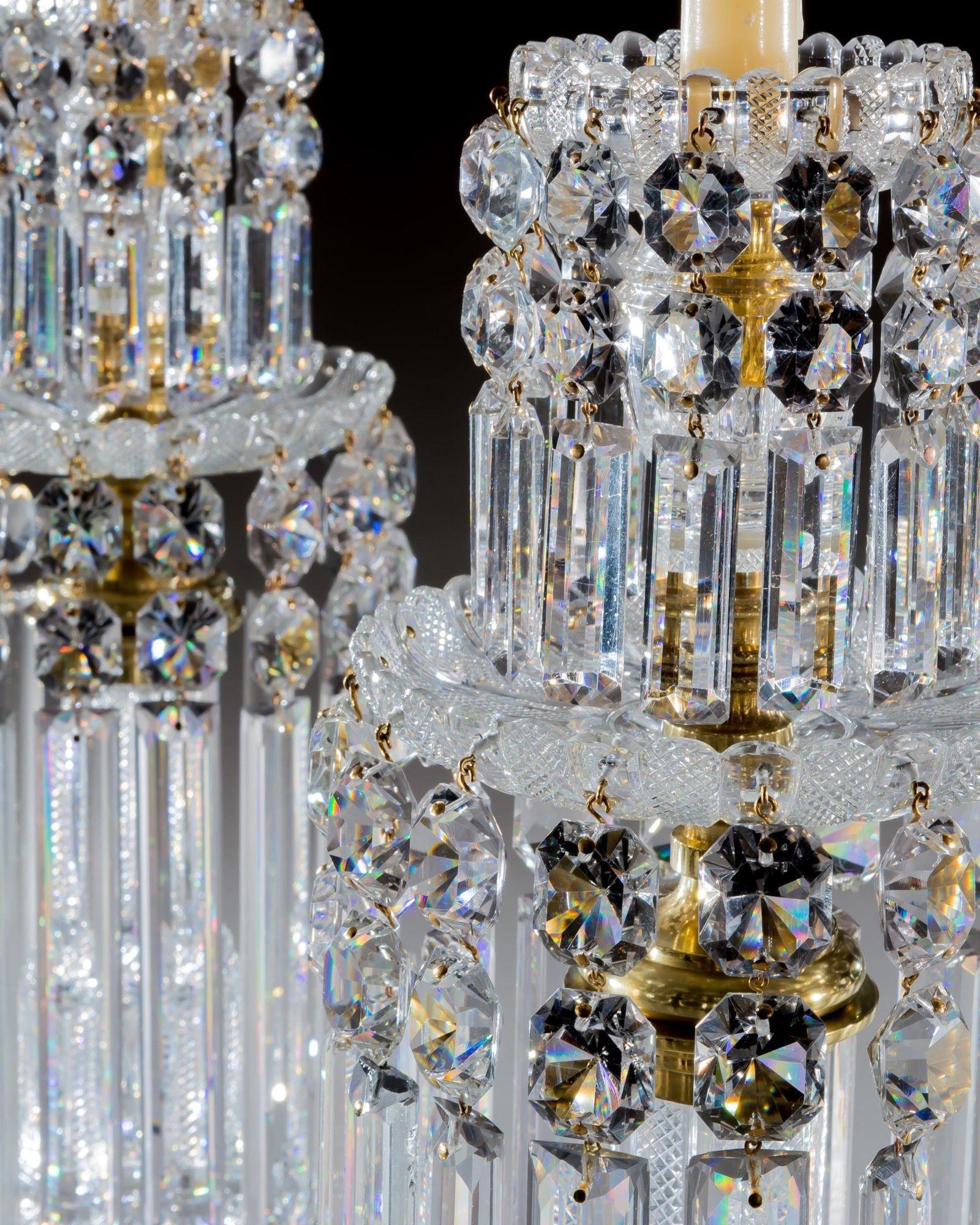 A superb quality pair of cut glass ormolu mounted lustre's, cut overall with pillar and diamond cutting, the double ogee base supporting drip pans and candle nozzles hung with the finest quality rule drops and spangles.