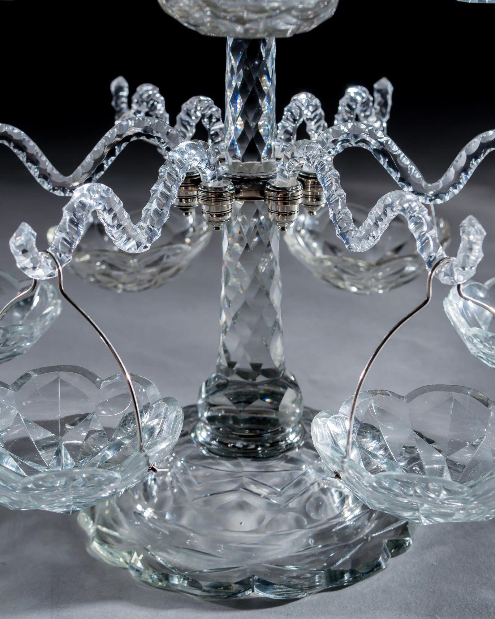 The rare Georgian cut glass and silver mounted sweetmeat tree has a flat cut base with tapering faceted column, issuing twelve branches suspending sweet dishes mounted with silver handles, and large central sweetmeat.