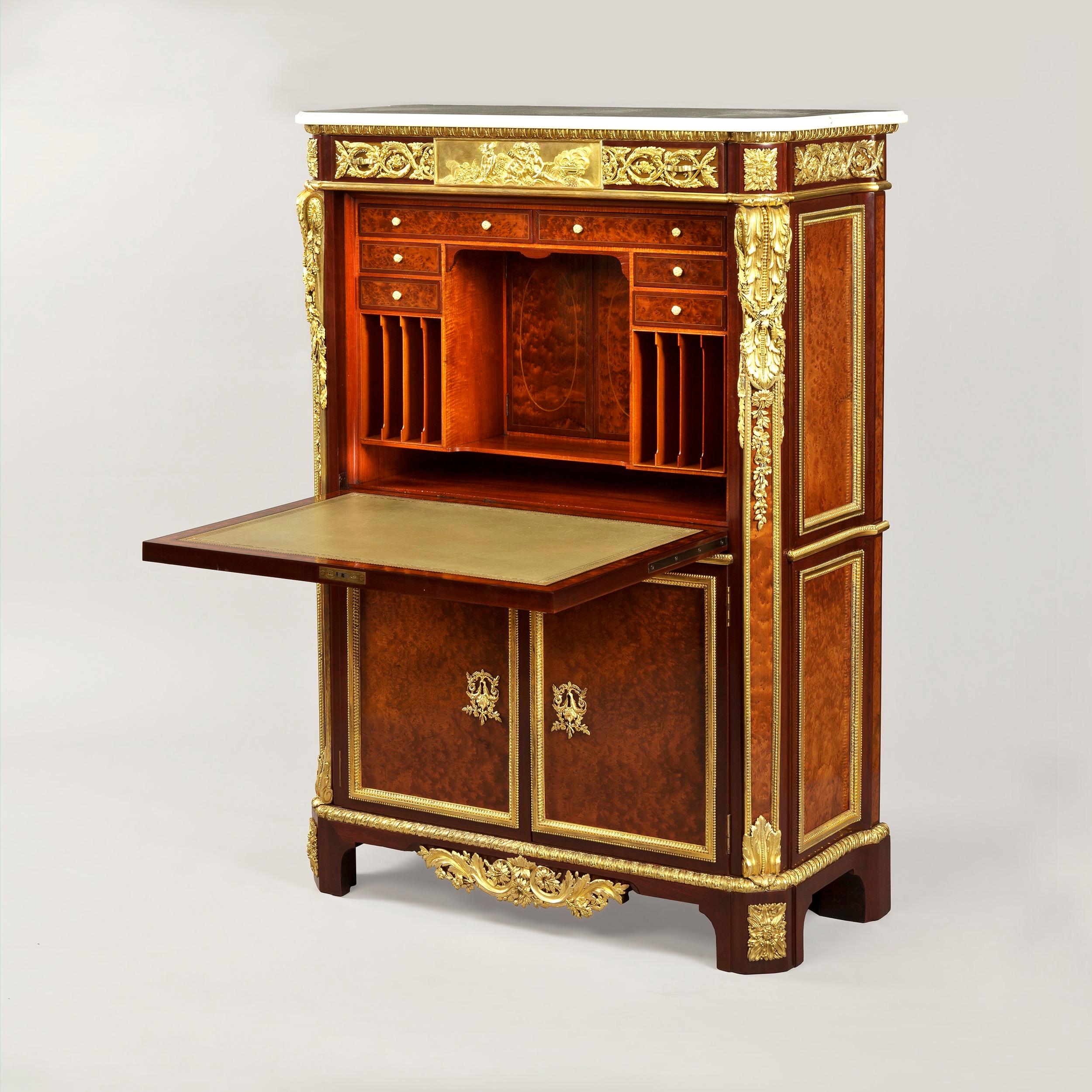 An Exceptionally Rare Secrétaire, 
After the J.H. Riesener example in The Wallace Collection

Of upright rectangular form with canted corners; veneered in thuya-wood, and banded in purple-wood, exuberantly dressed with gilt bronze mounts of the